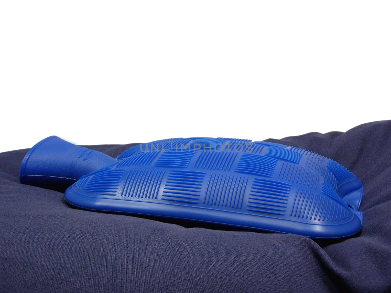 Blue hot water bottle on blue pillow