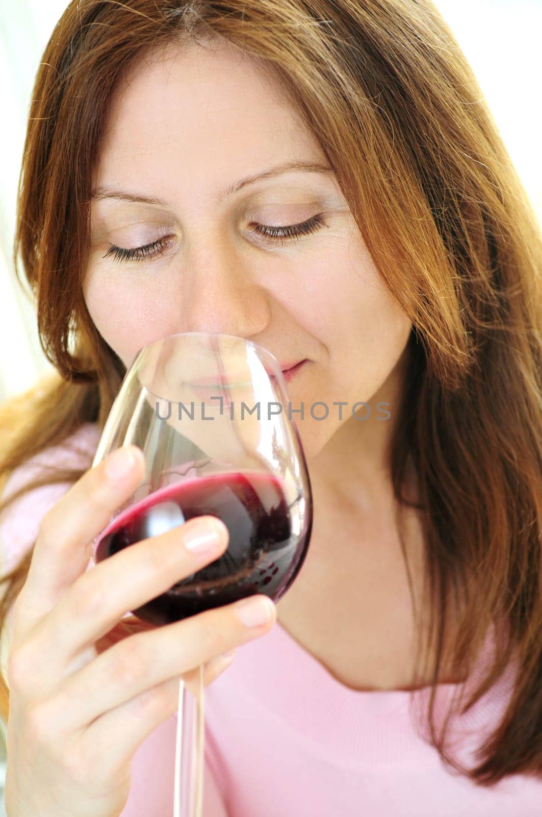Mature woman with a glass of red wine