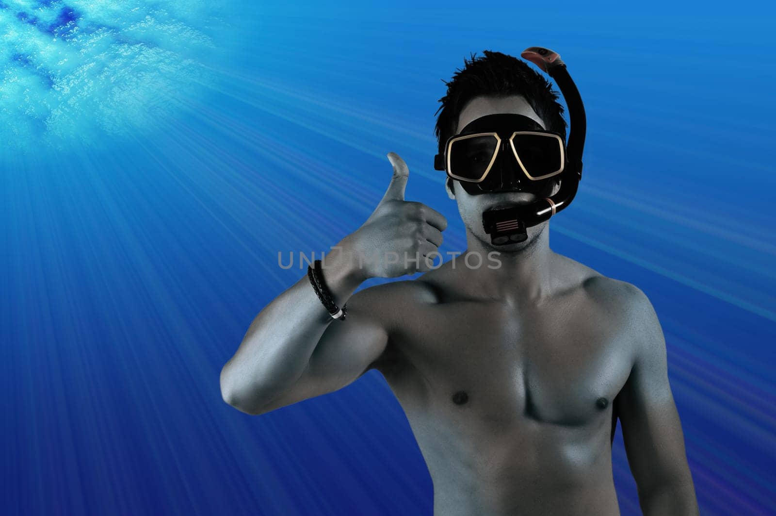 Man under blue water thumbs up