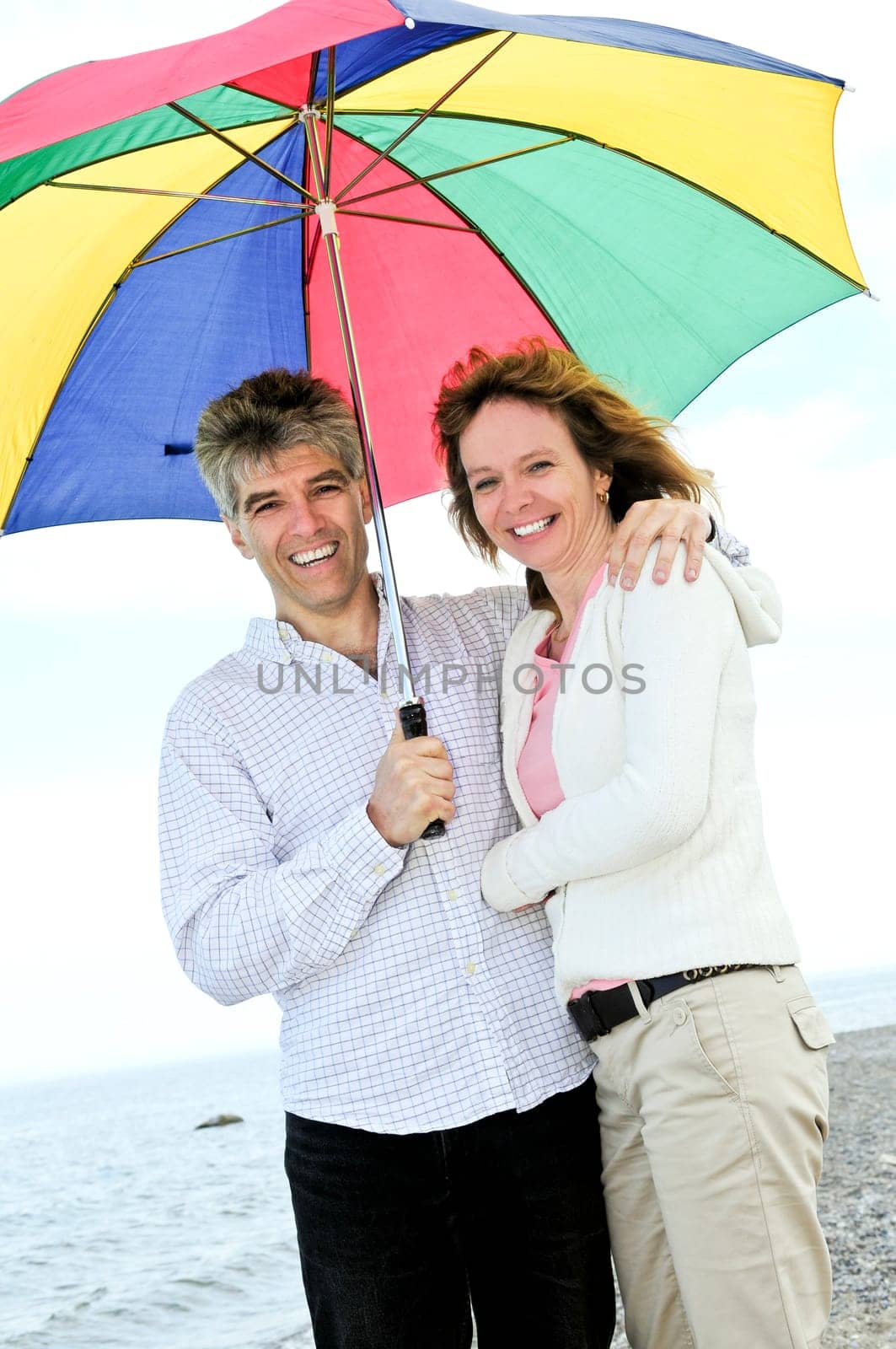 Happy mature couple with umbrella
