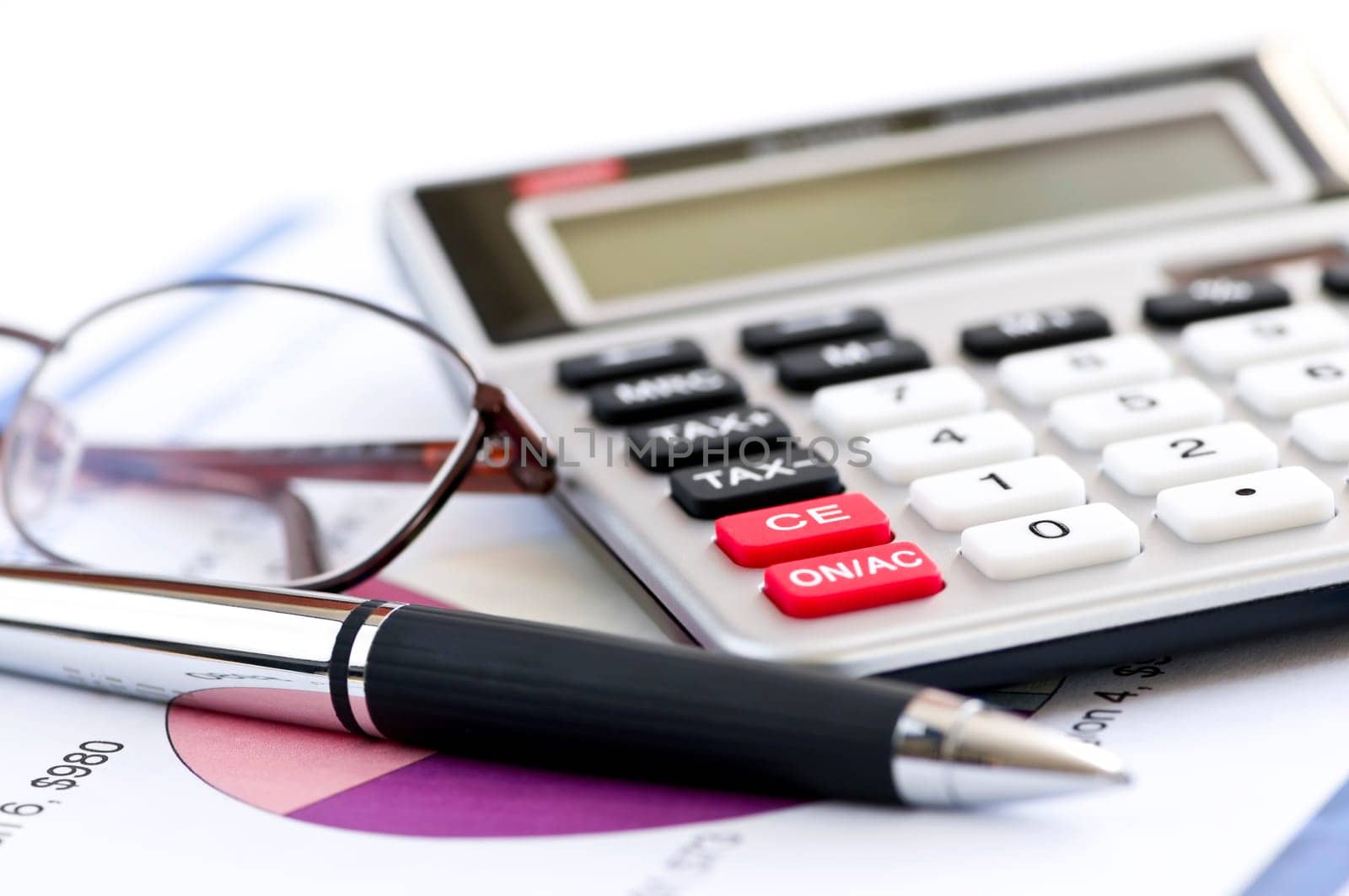 Tax calculator pen and glasses