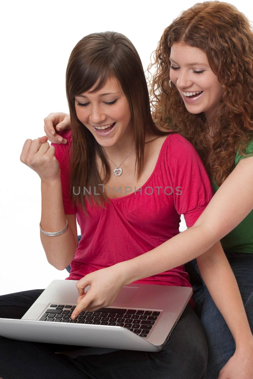 Two teenagers using laptop