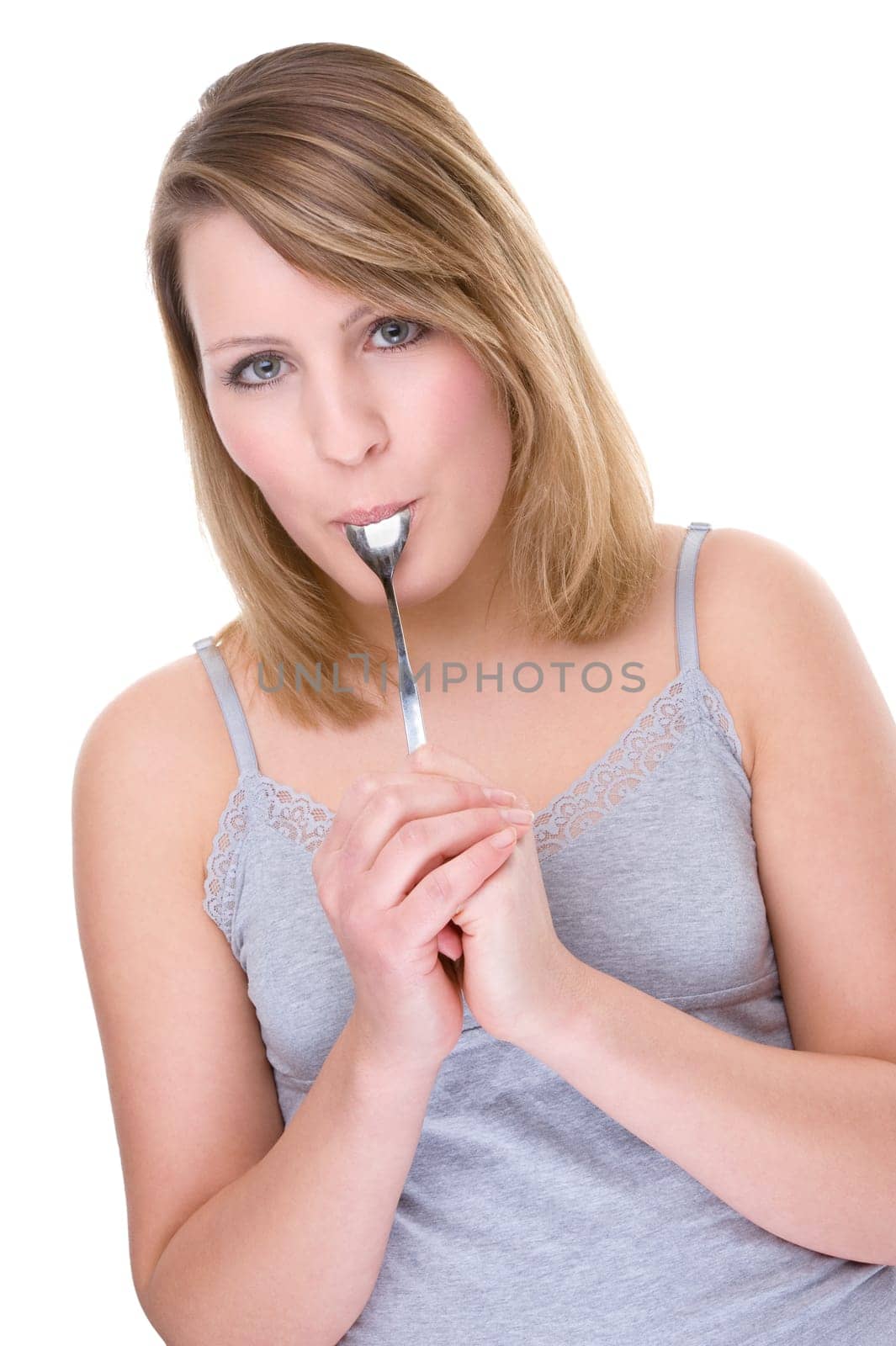 Young woman licking a spoon