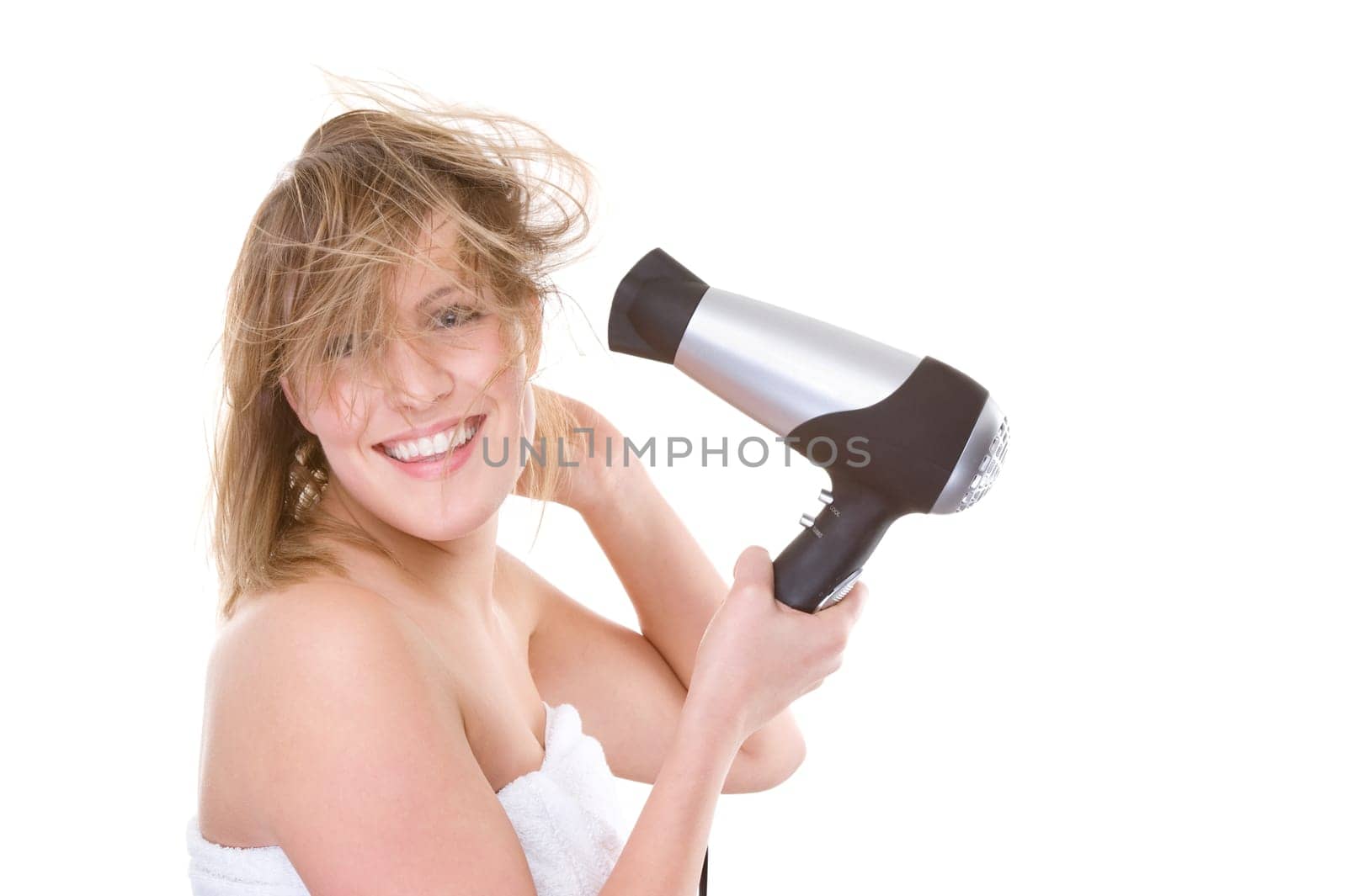 Young woman blow-drying her hair