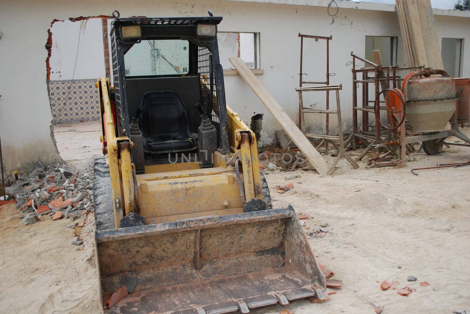 Yellow caterpillar and cement mixer