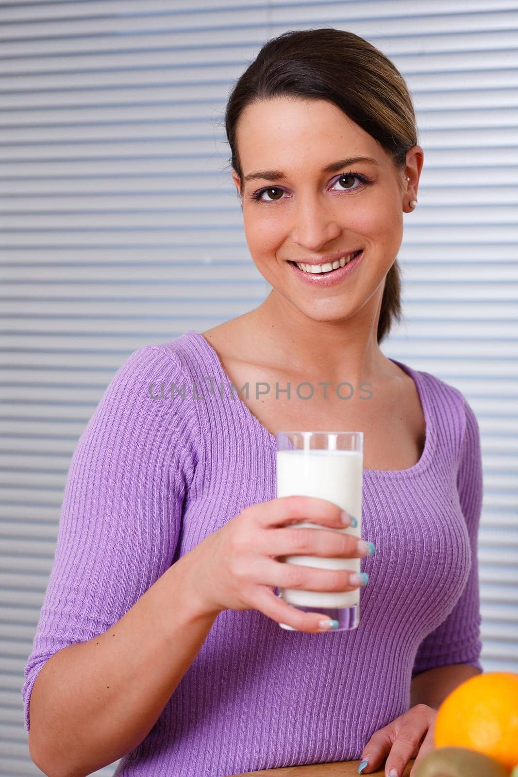 Young woman with a glass of fresh milk