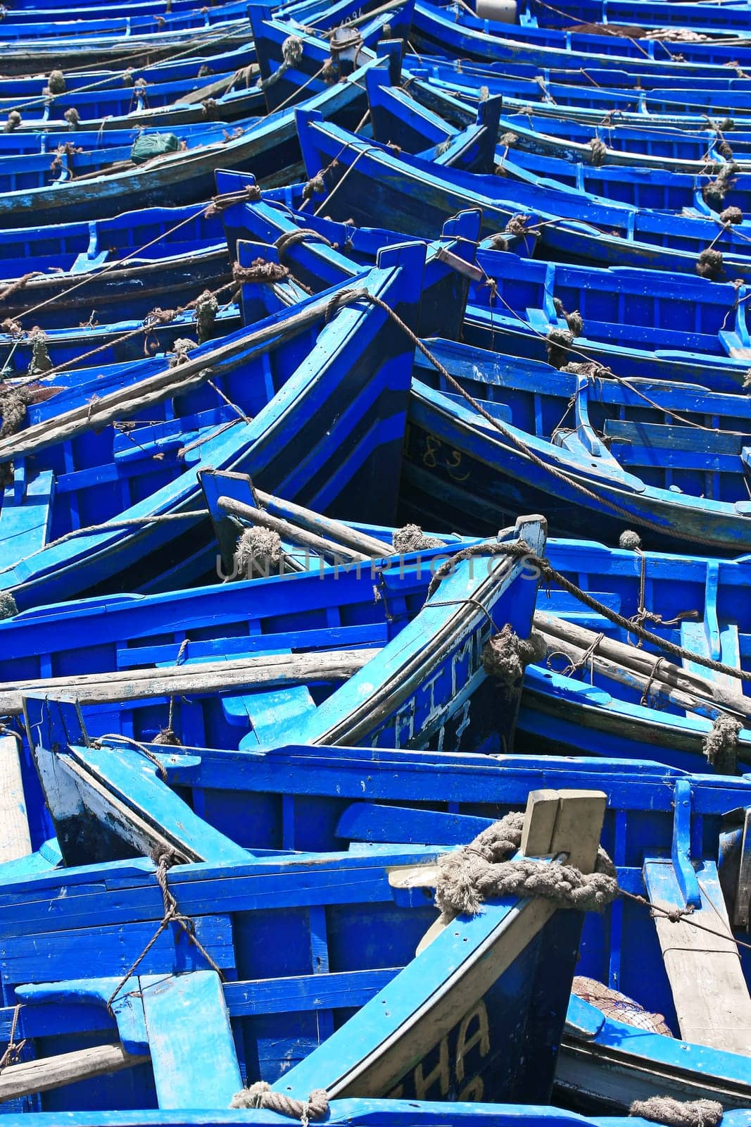 blue fishing boats in sunlight