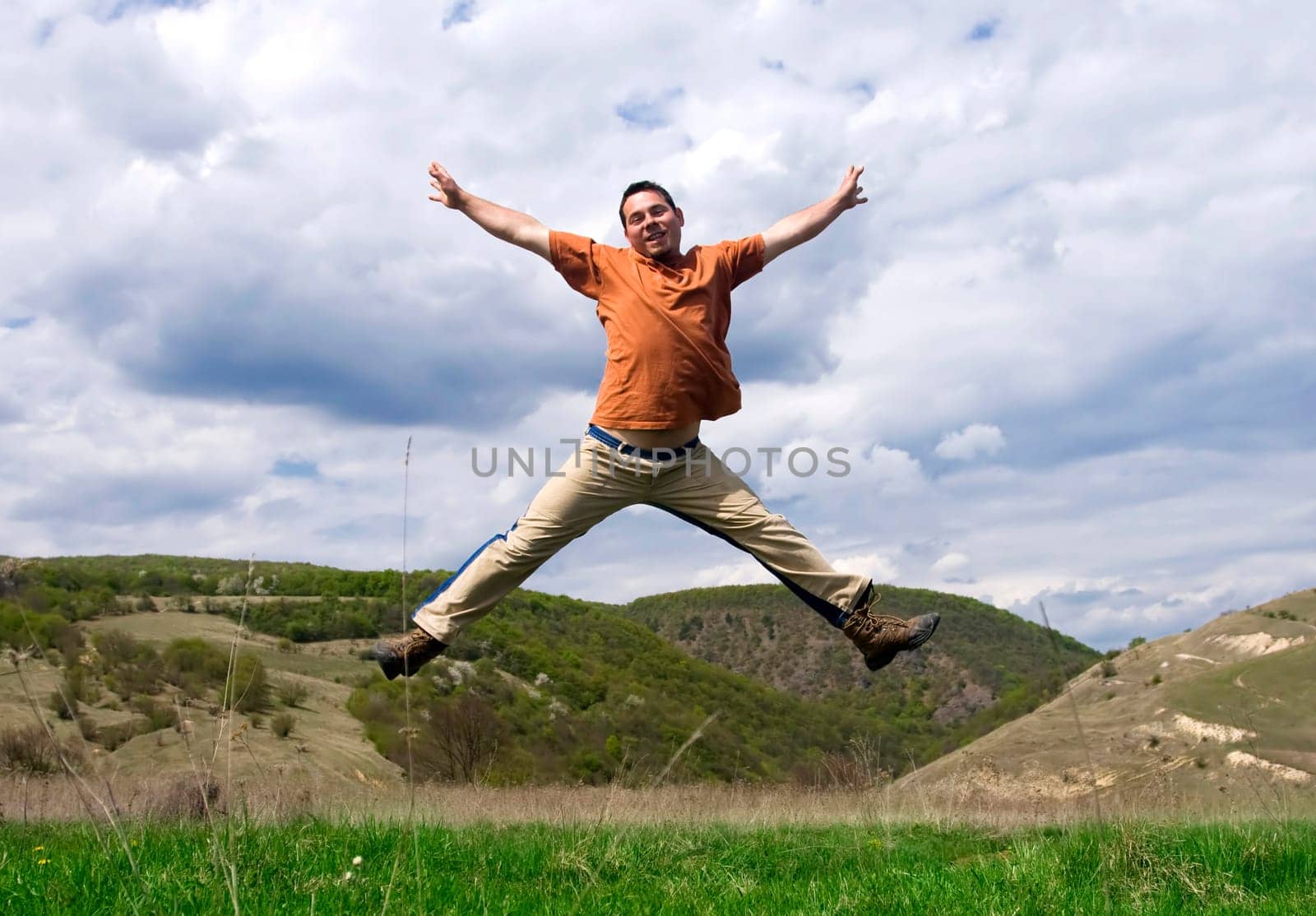 Young handsome man jumping for joy