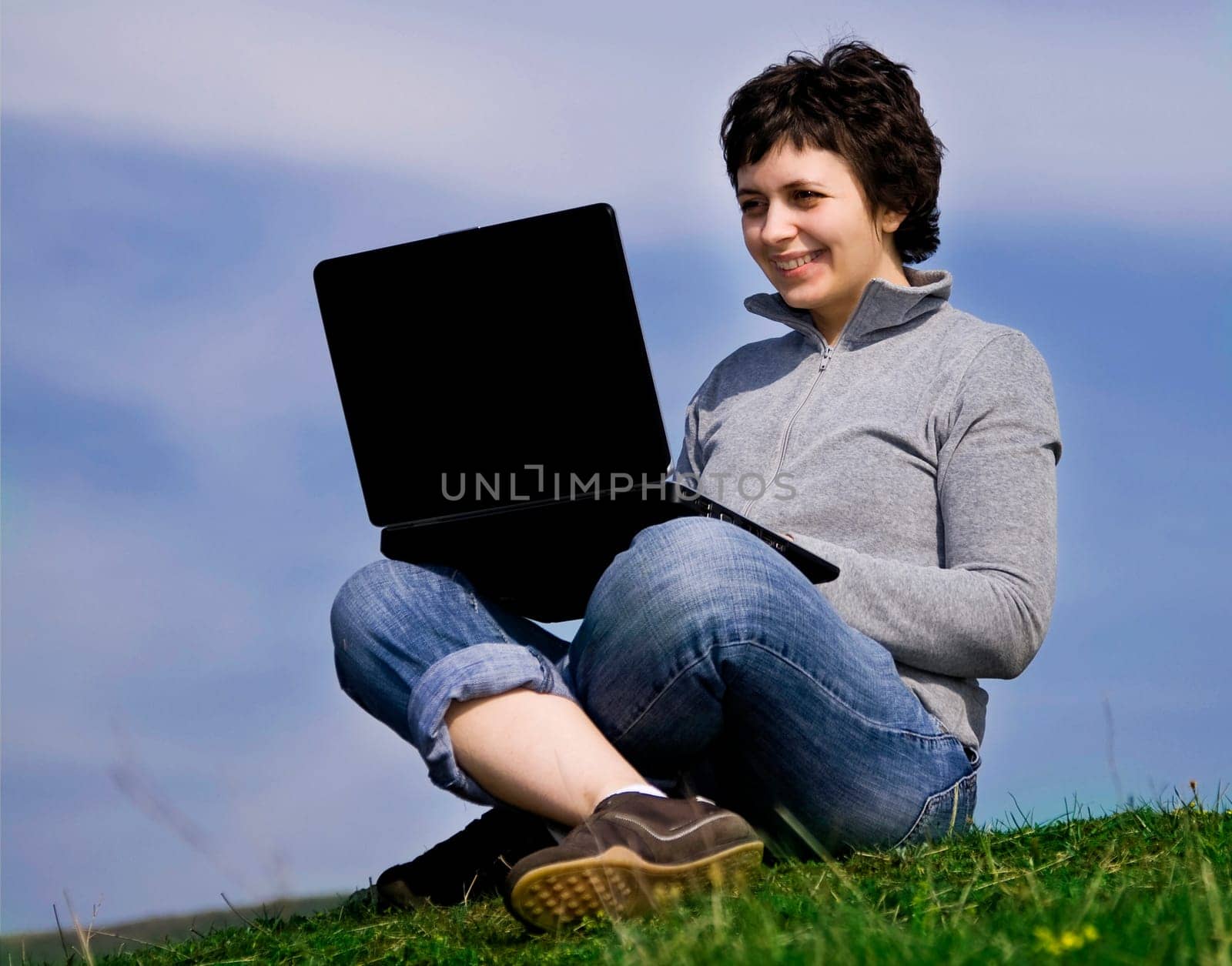 Young casual woman working on laptop