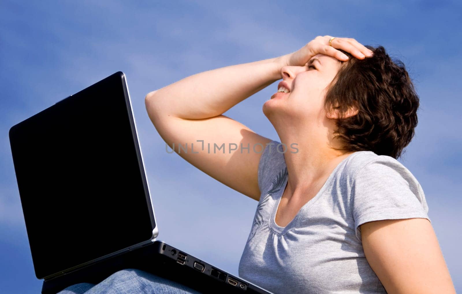 Young casual woman working on laptop