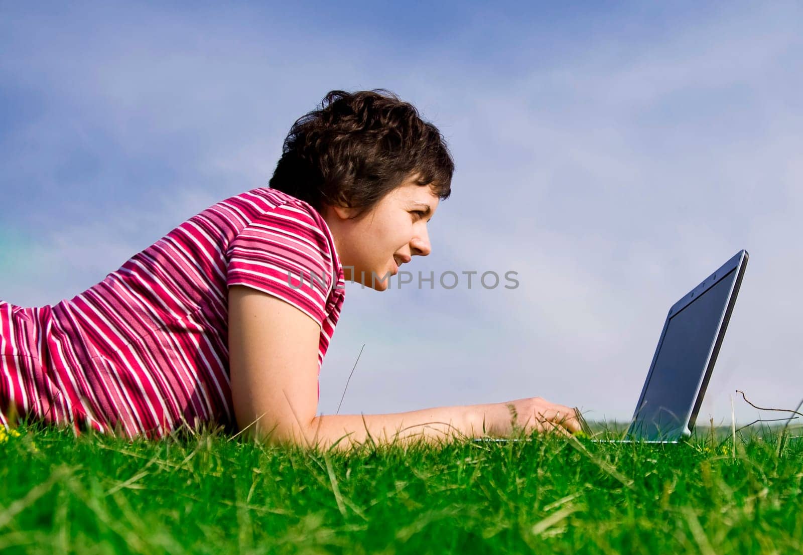 Young casual woman working on laptop