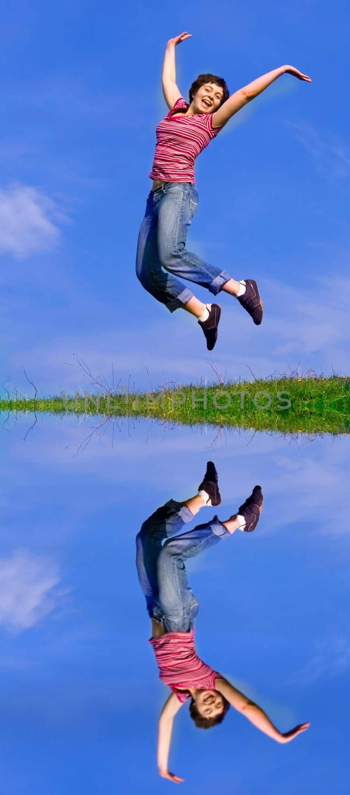 Young happy woman jumping high against b