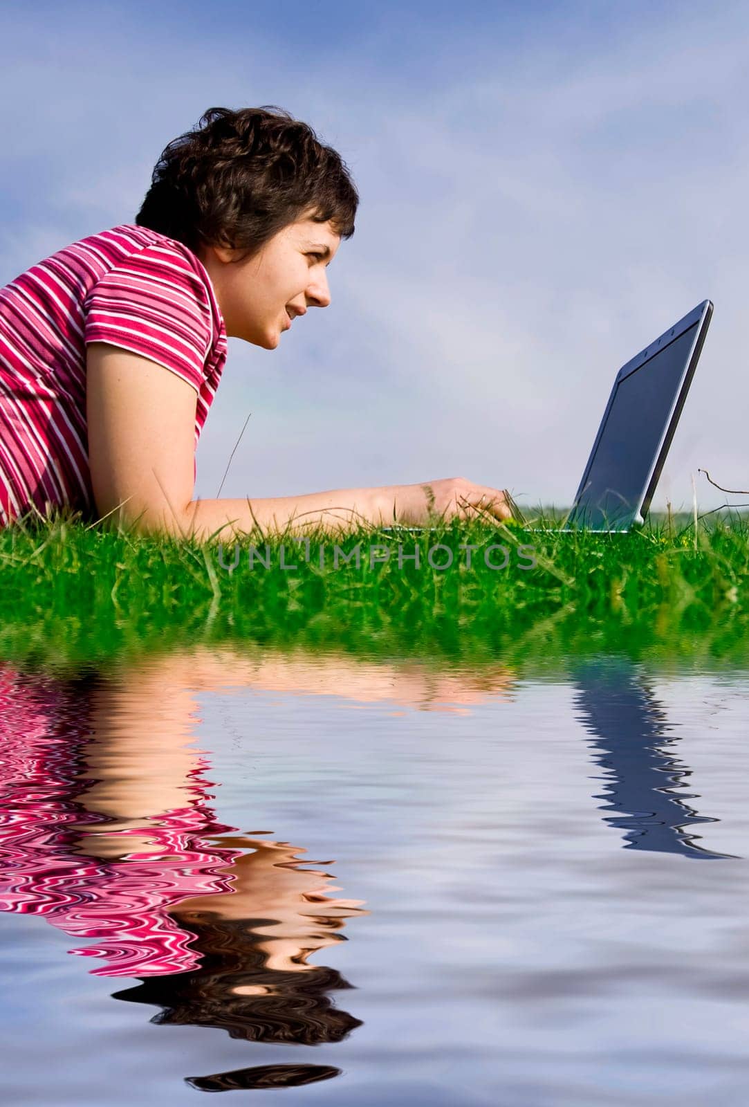Young casual woman working on laptop out