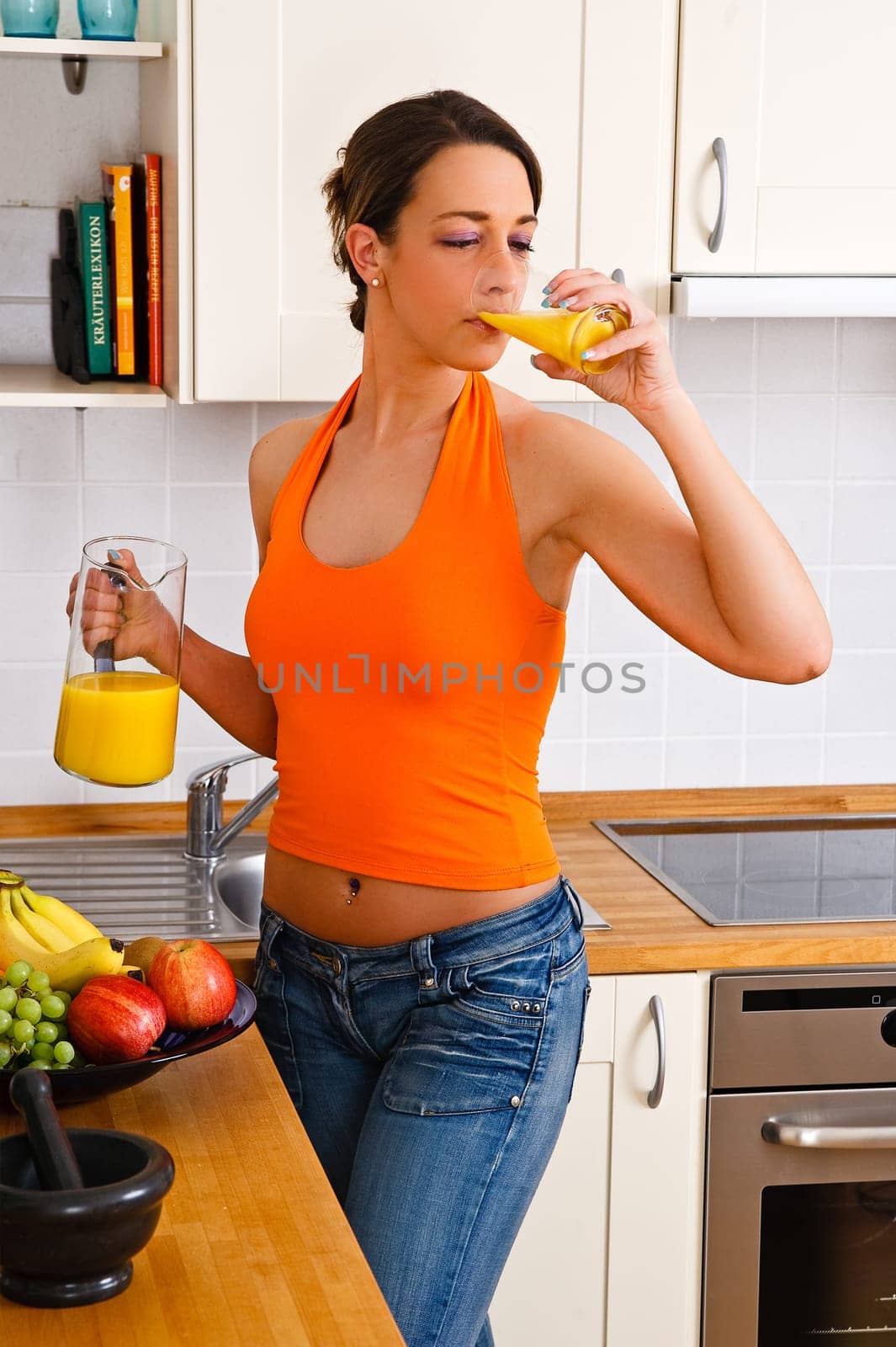 Young woman drinking a glass of orange juice