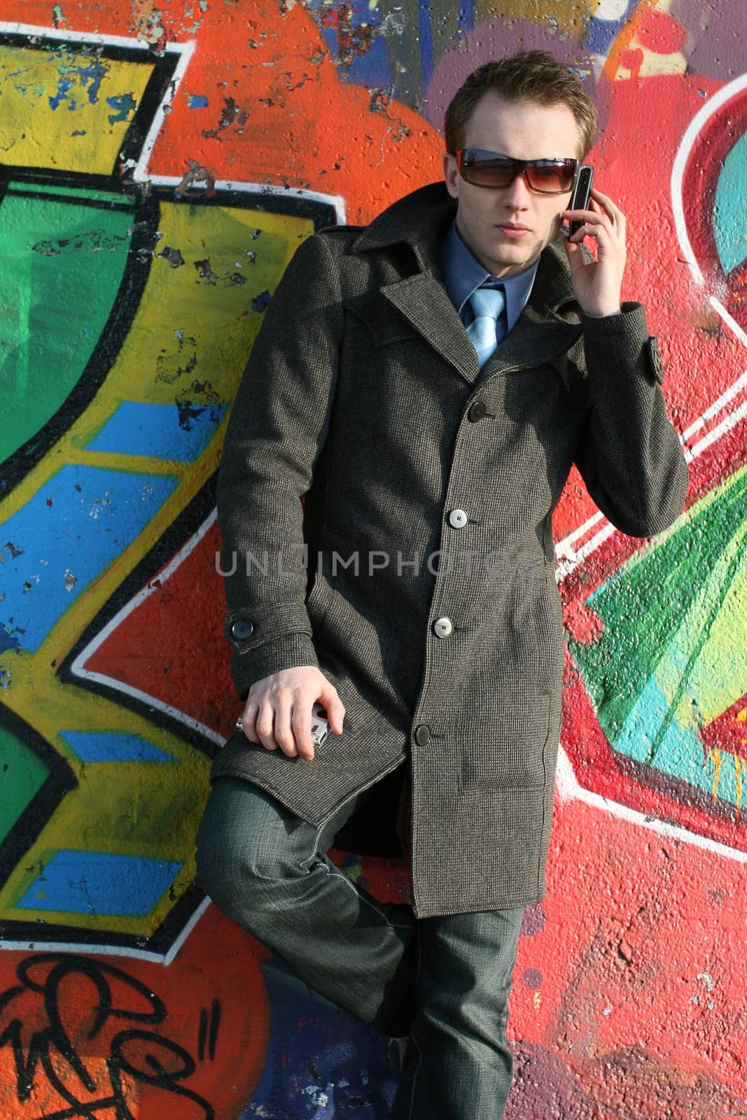 Serious man talking on the phone outdoors