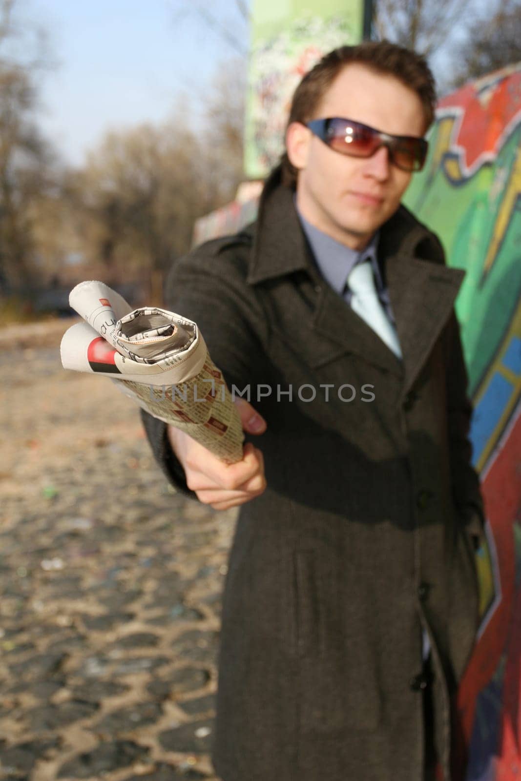 Man pointing with newspaper