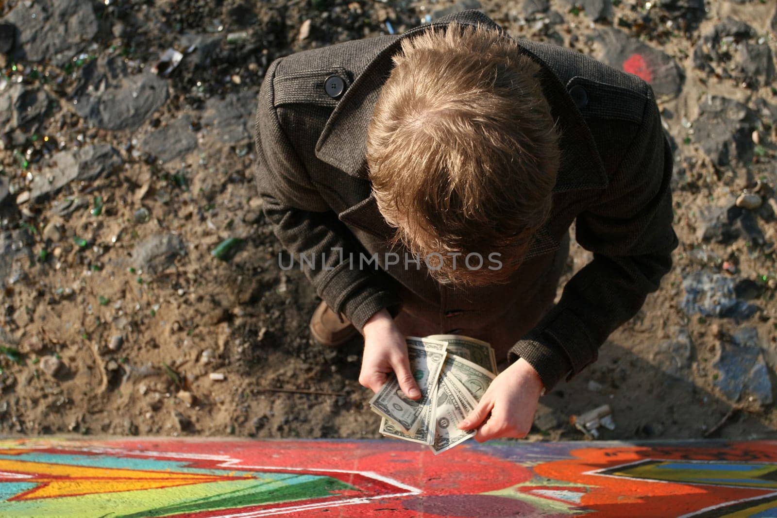 Man counting money outdoors