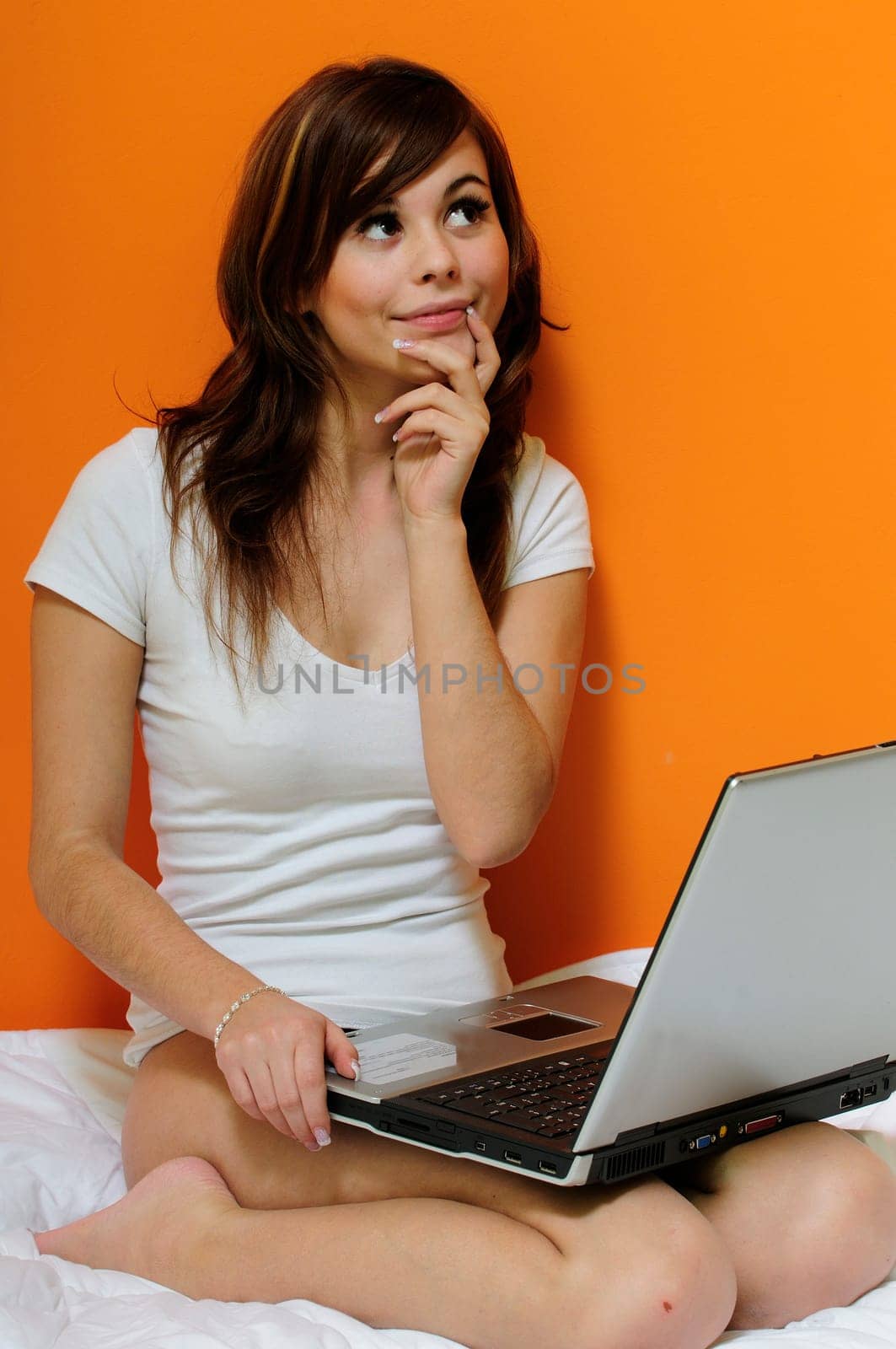 Girl with laptop in bed