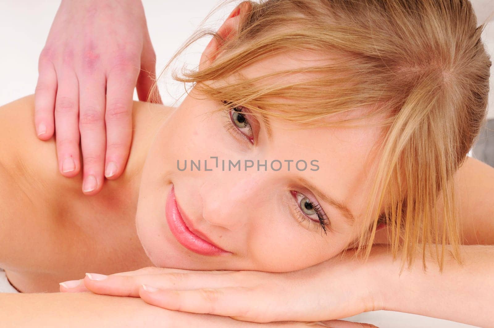 Blonde woman receives a relaxing massage