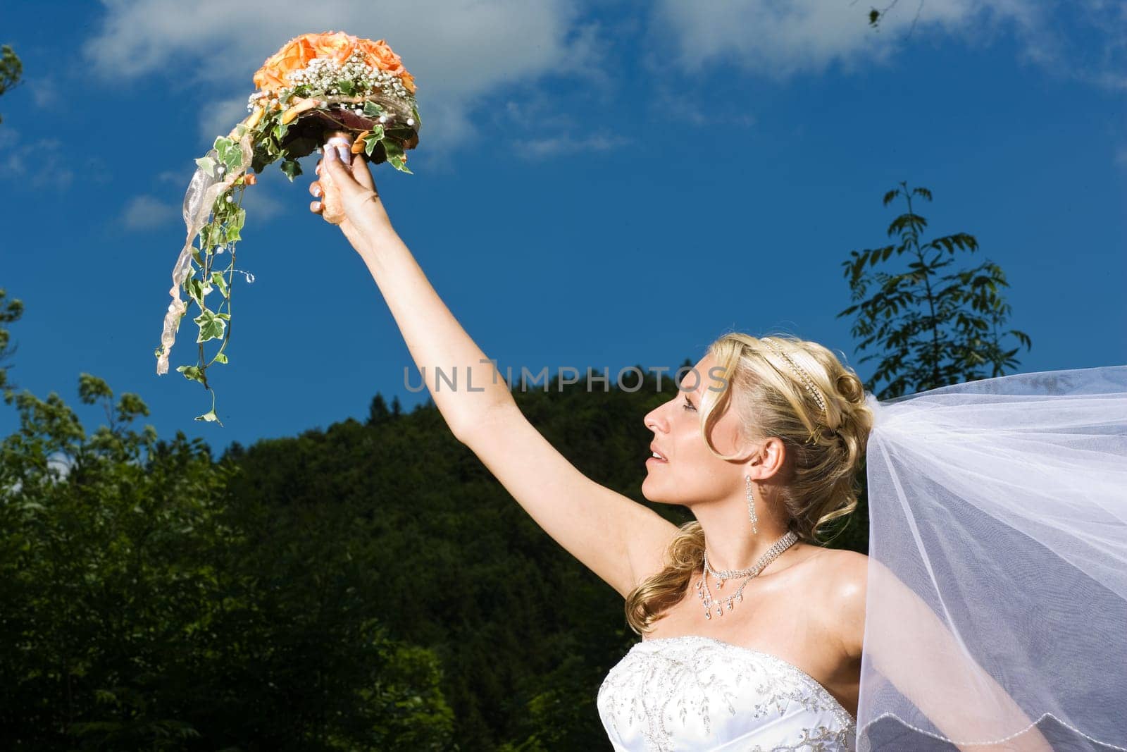 Bride stretches out bouquet of flowers