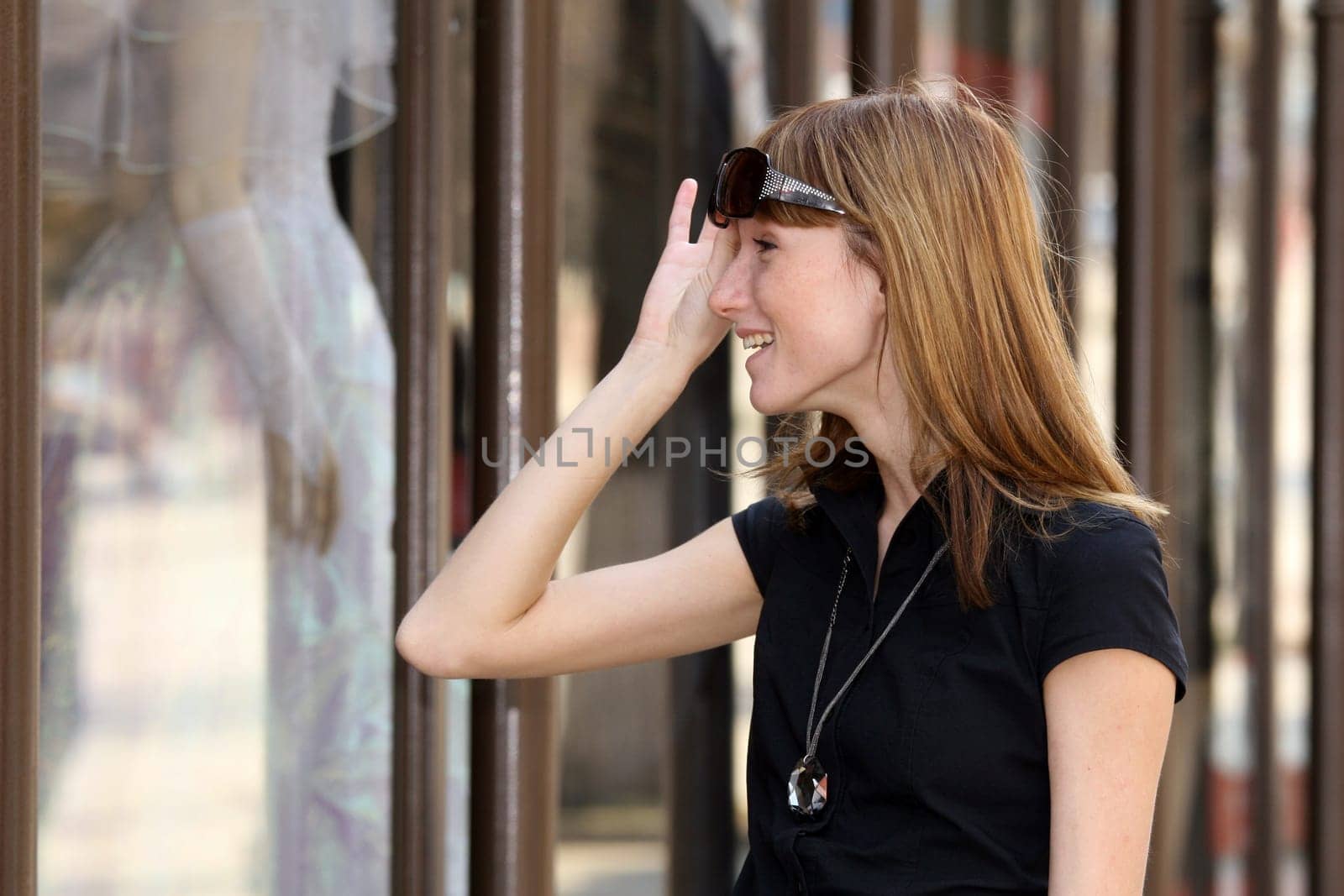 Surprised woman in front of the shop window