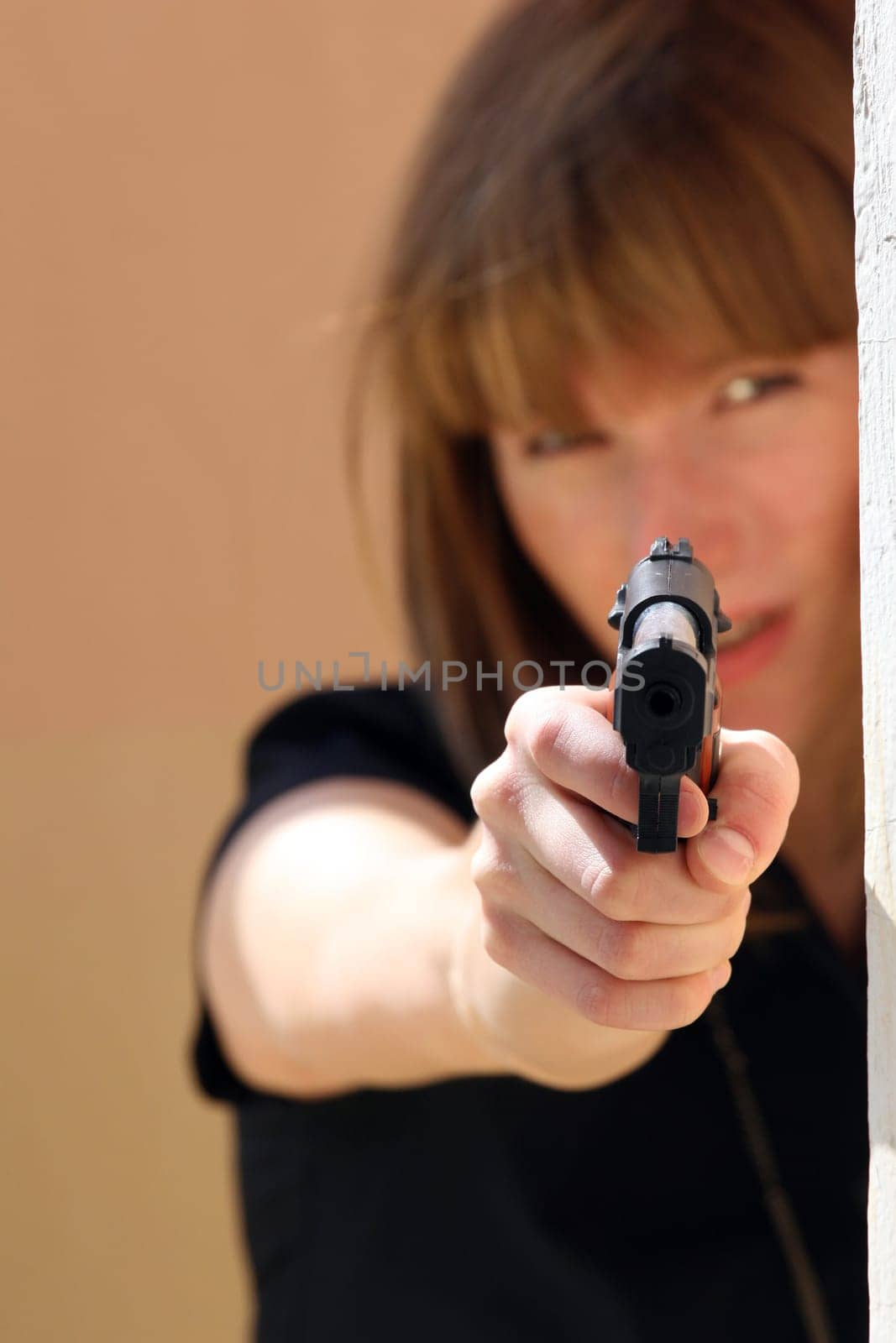Woman aiming with gun