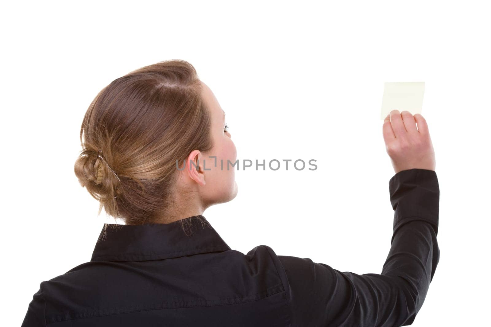 Businesswoman sticking notes on wall