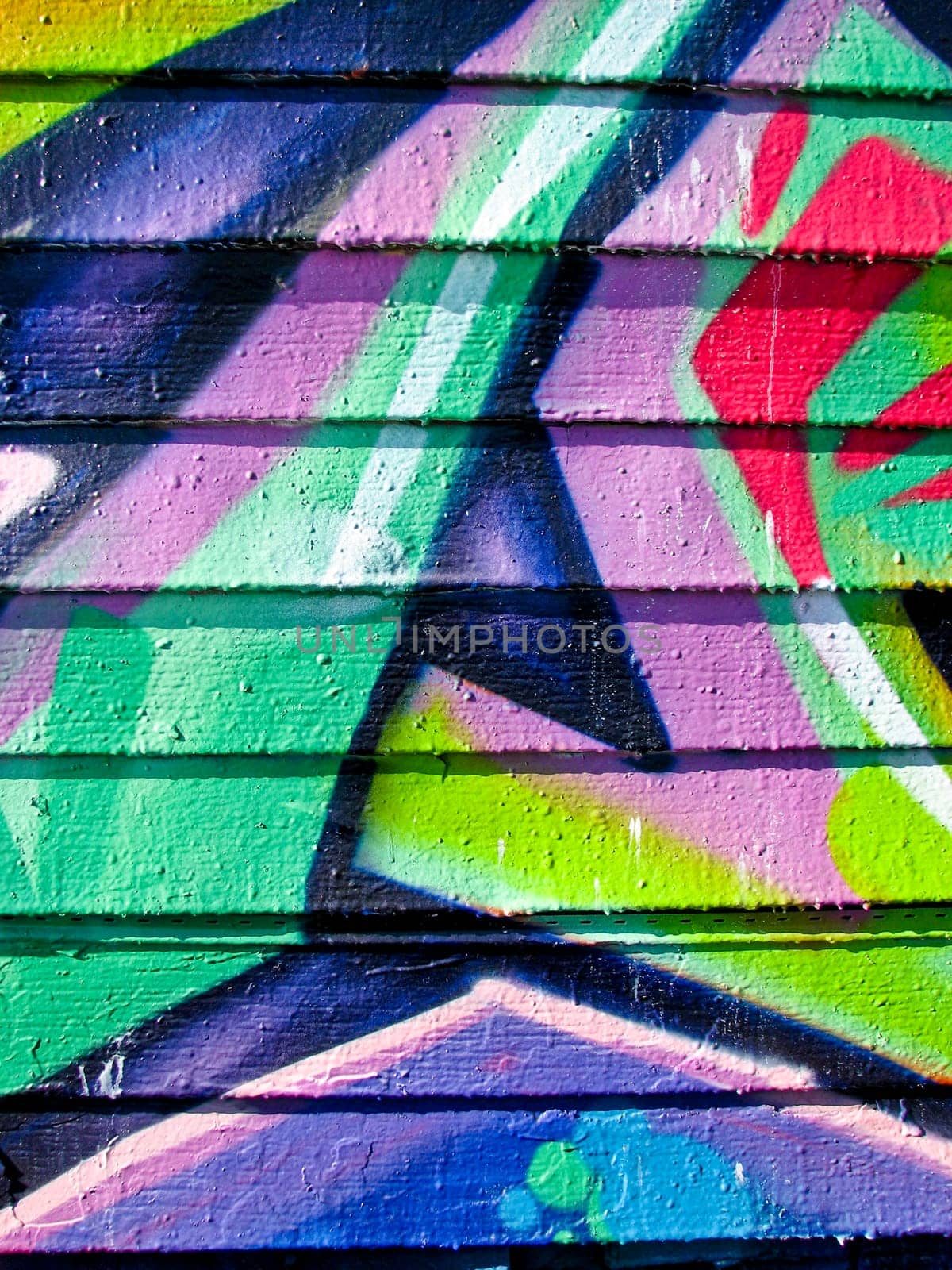 Vibrant graffiti on wood slatted wall