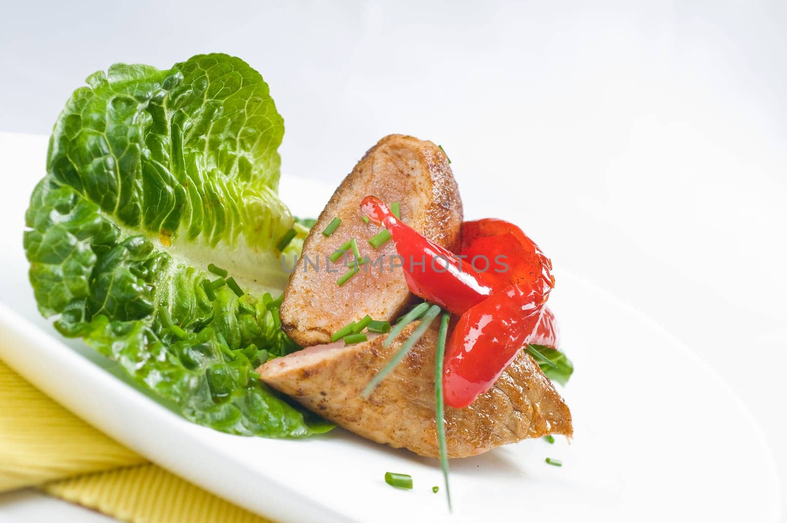 Pork tenderloin,fried on salad with chives