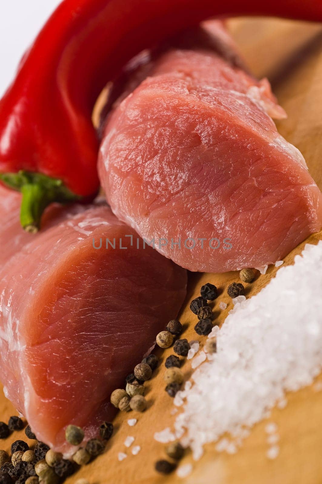 Raw pork tenderloin on wooden board