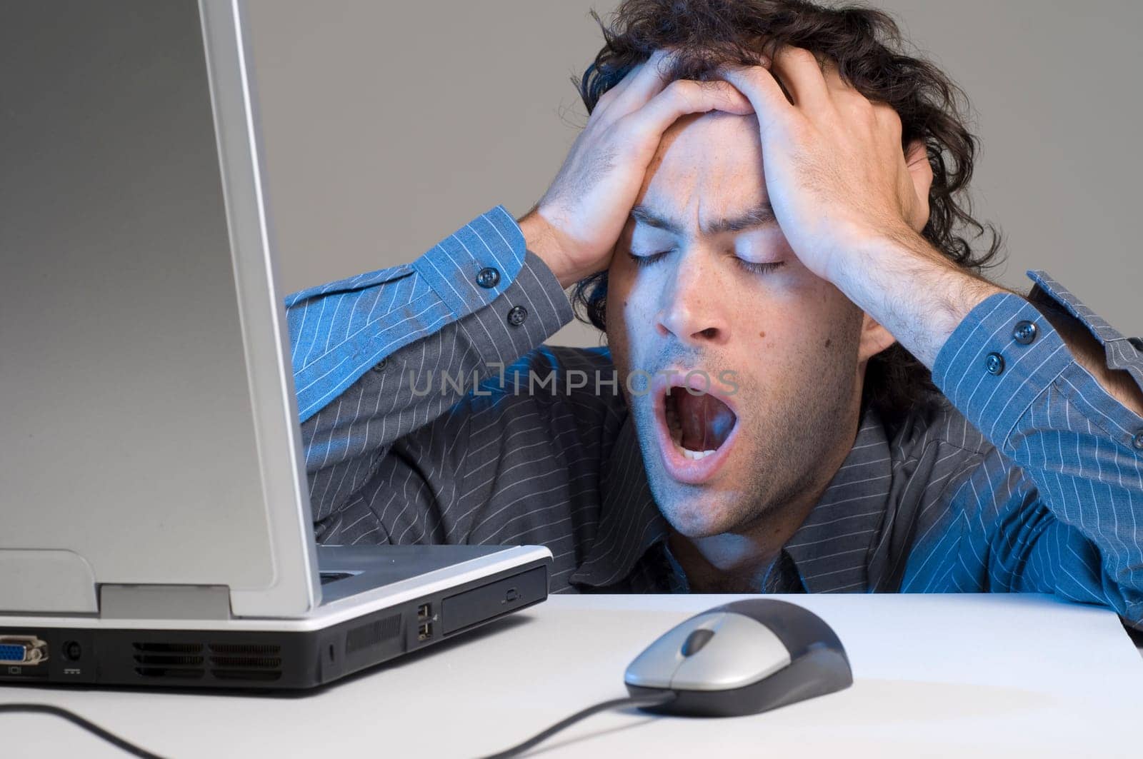 Tired man at computer desk