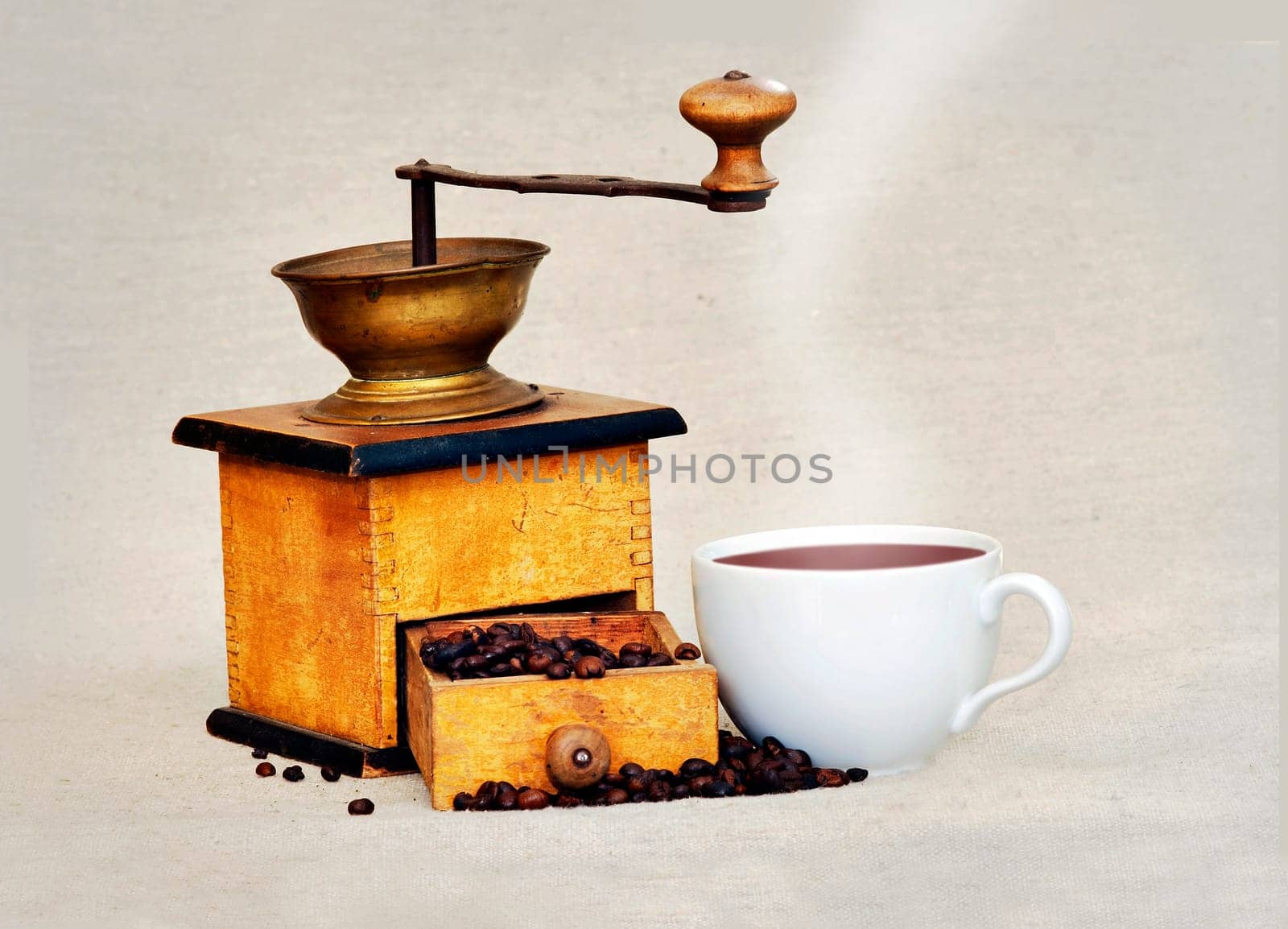 coffee mill and cup of hot black coffee
