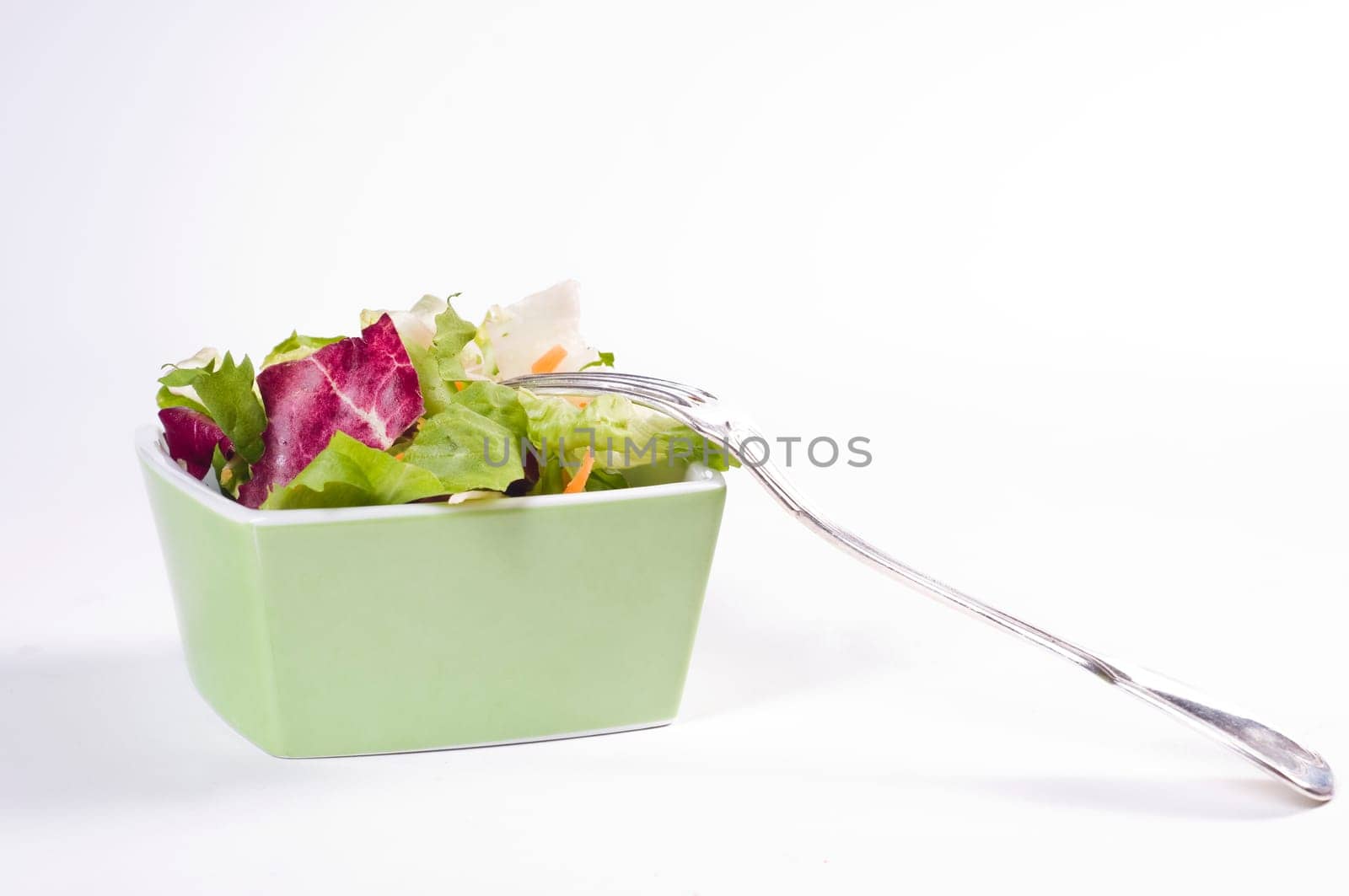 Mixed salad in green bowl