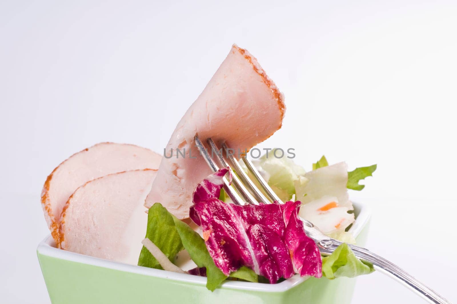 Mixed salad in green bowl
