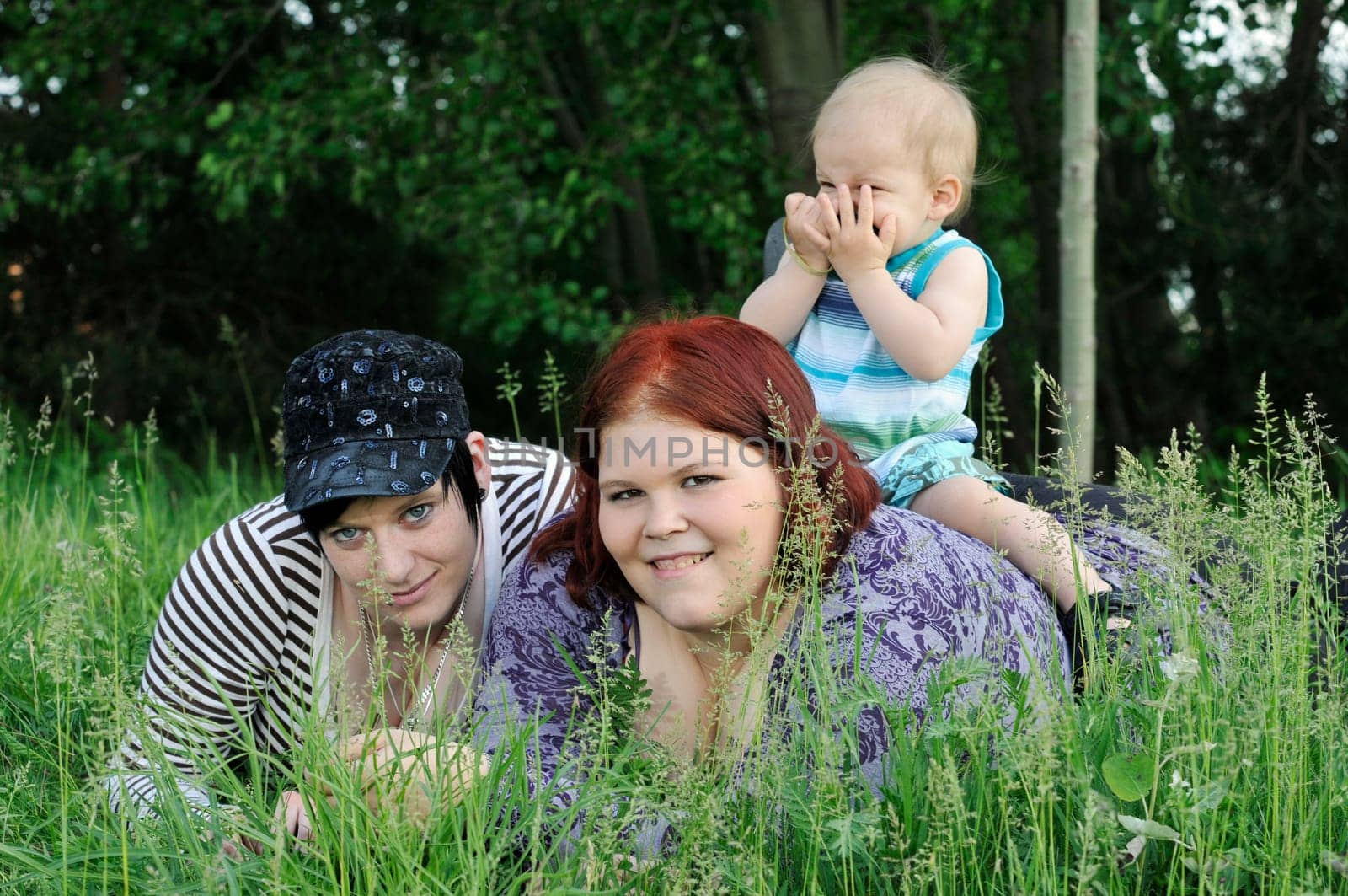 three people in the grass