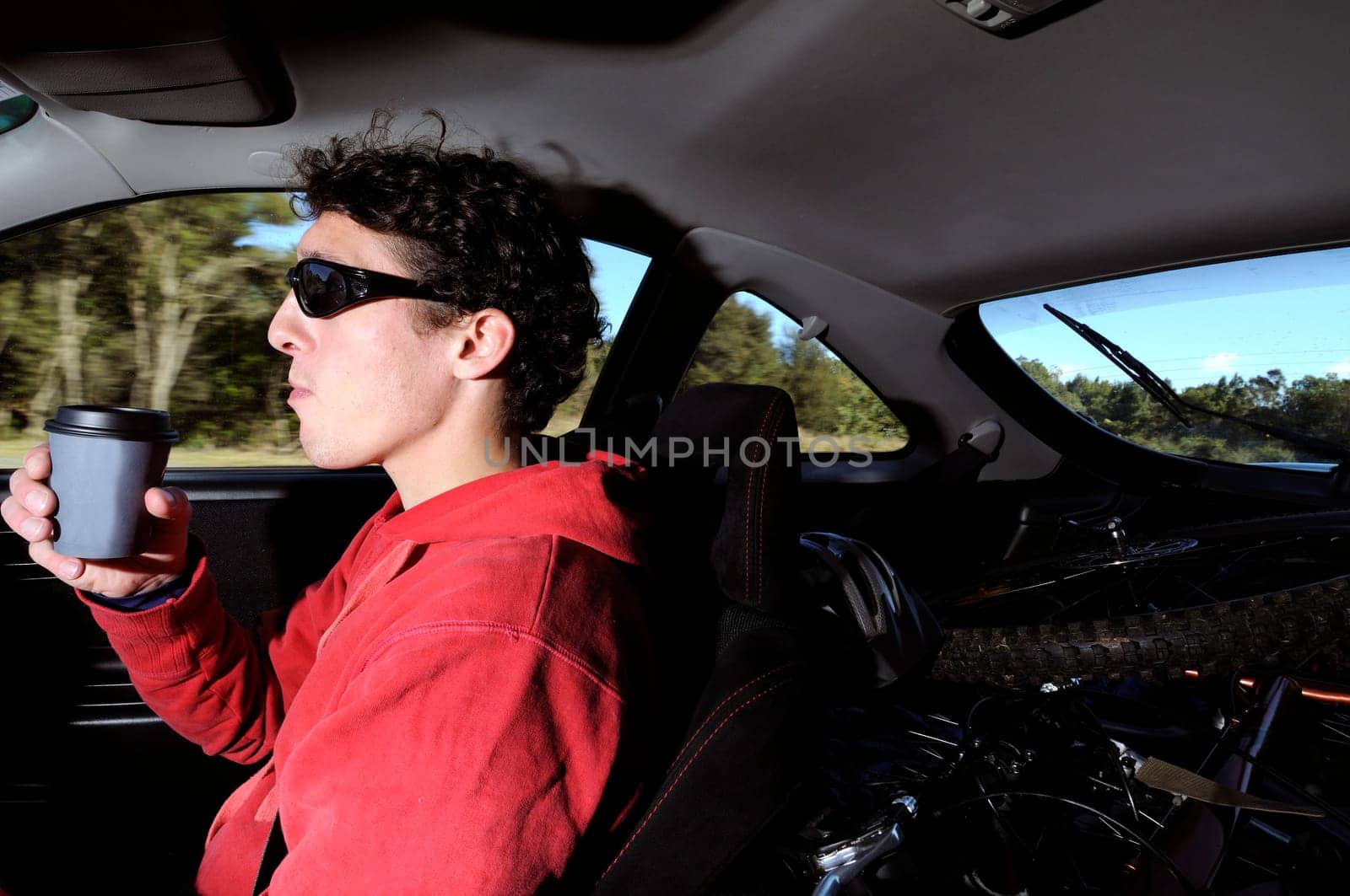 Man driving while drinking coffe