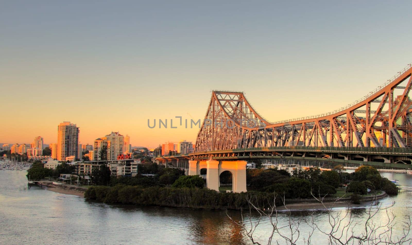 The iconic Story Bridge spanning the Brisbane River in Brisbane Australia at sunrise.