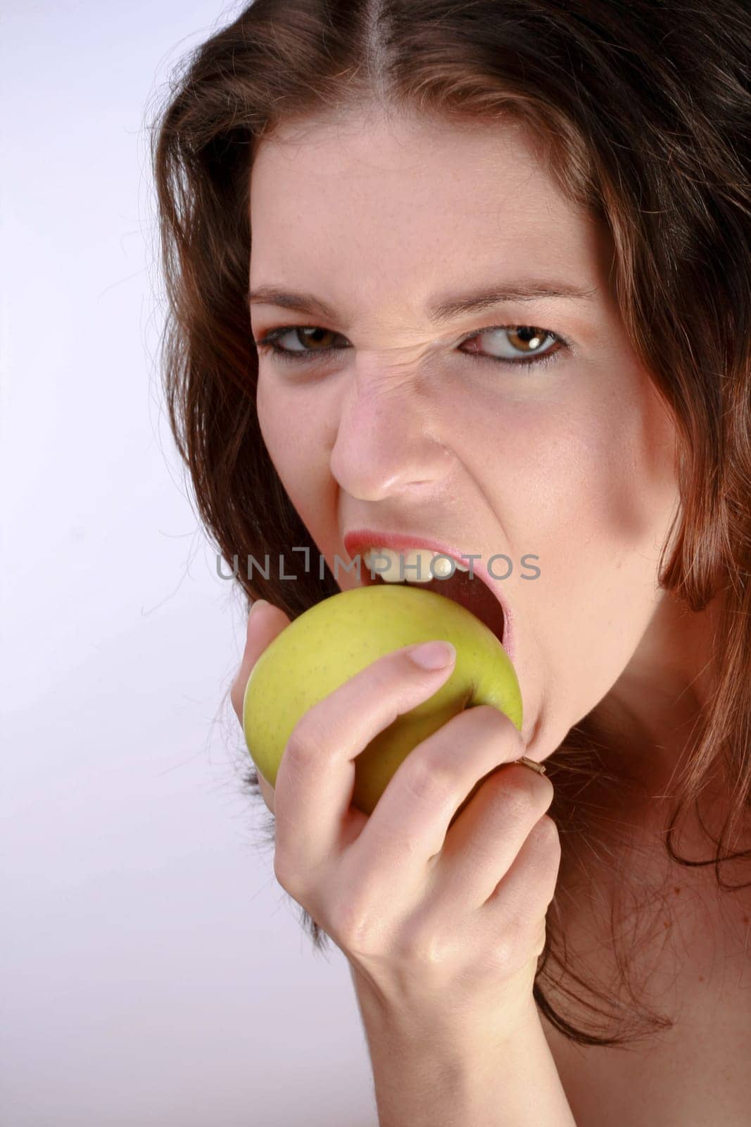 Beautiful Woman Biting A Green Apple
