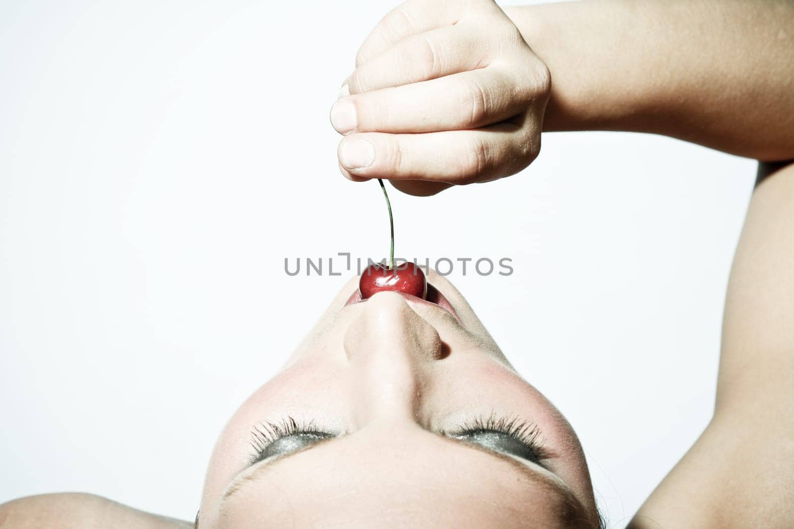 Woman Tasting A Cherry