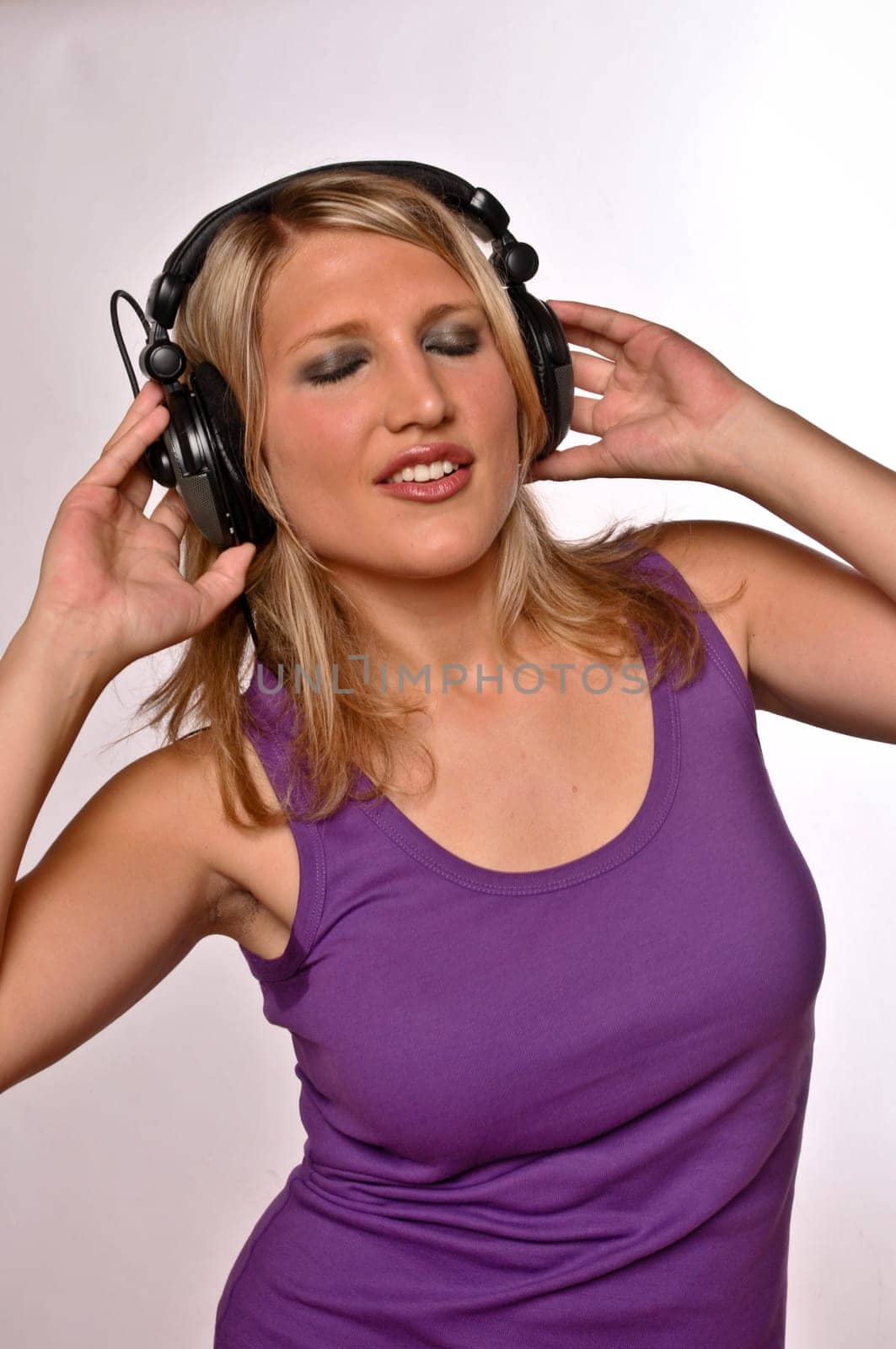 Blond Woman Listening On Headphones