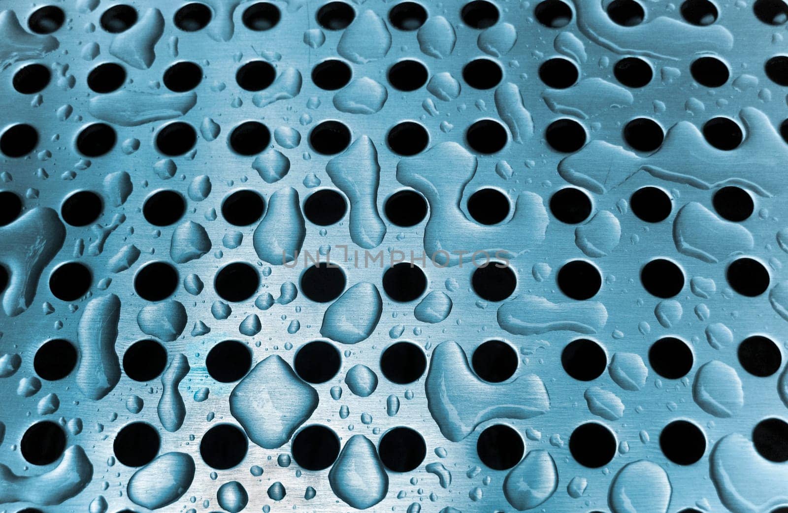 Rain drops on a metal grate
