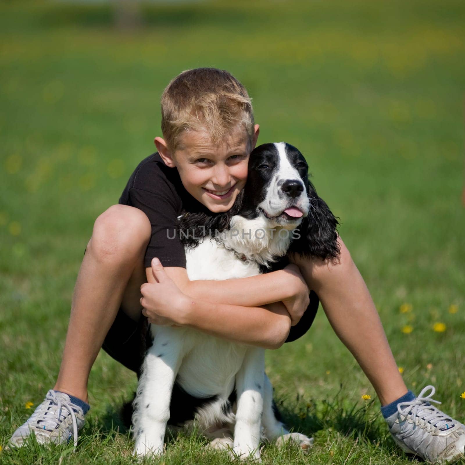 A boy poses with his puppy