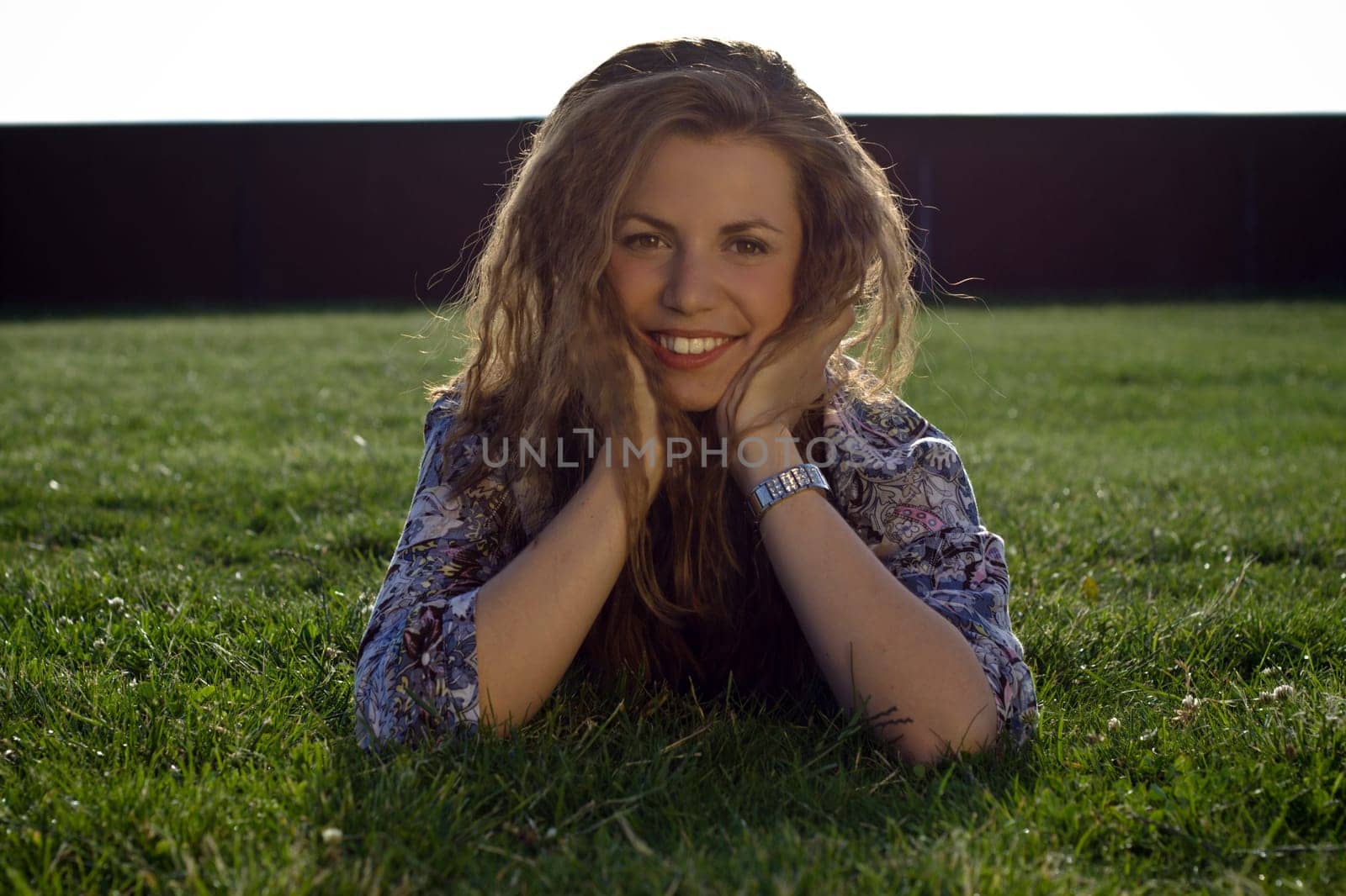 Pretty Blonde Girl Lying On Grass