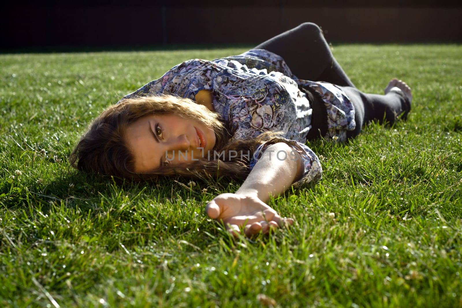 Cute Blond Girl Lying Back On Grass