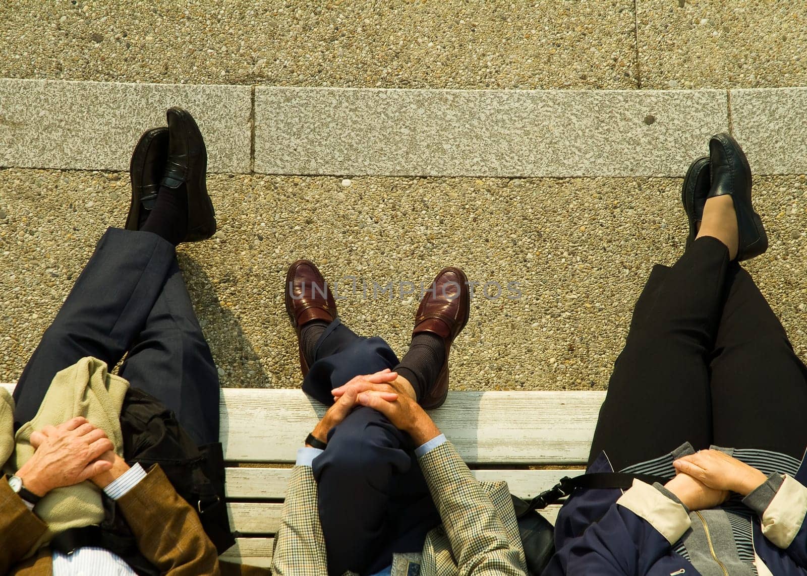 Legs of people on a bench