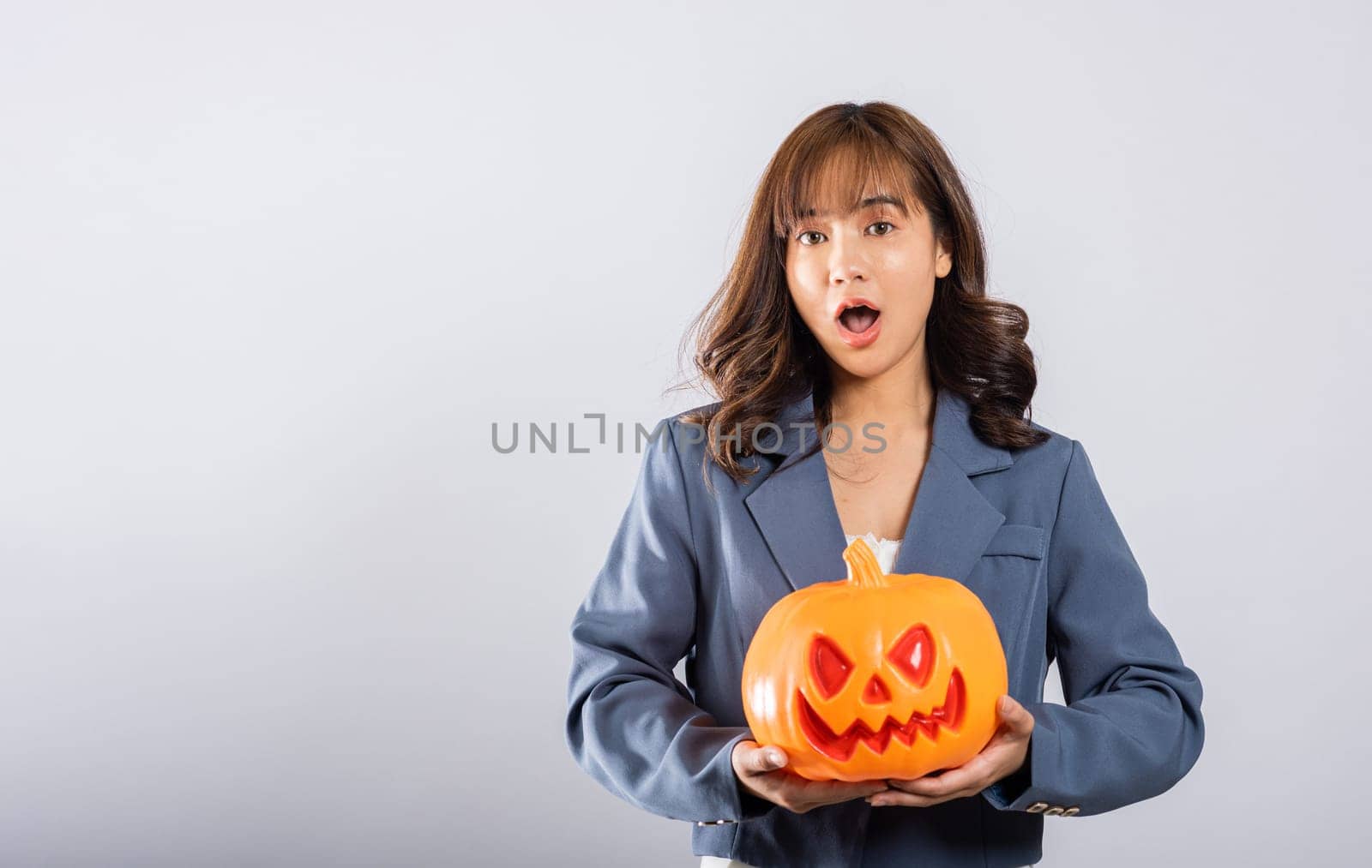 woman holding orange model pumpkins by Sorapop