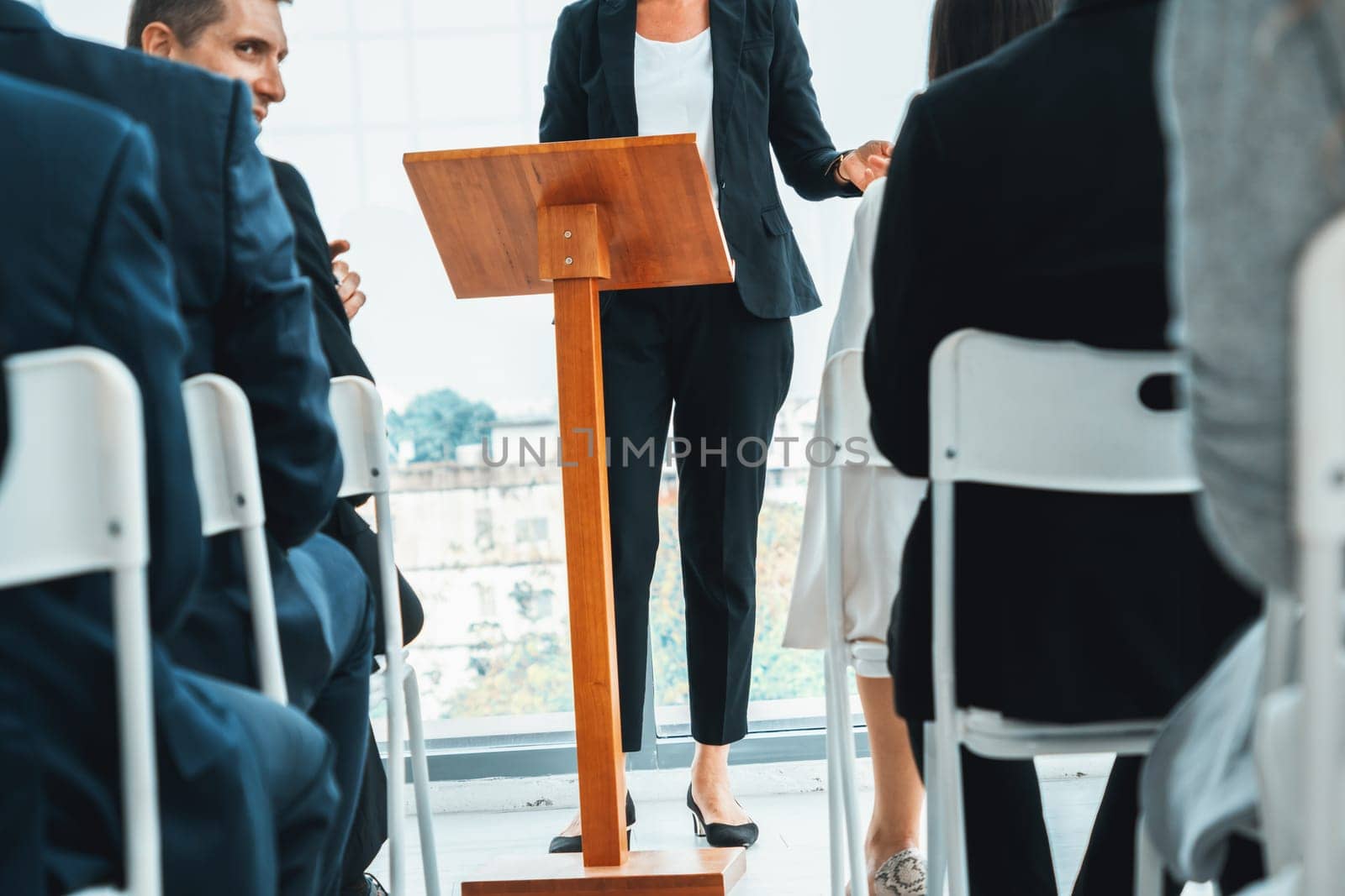 Group of business people meeting in a seminar conference . Audience listening to instructor in employee education training session . Office worker community summit forum with expert speaker . Jivy