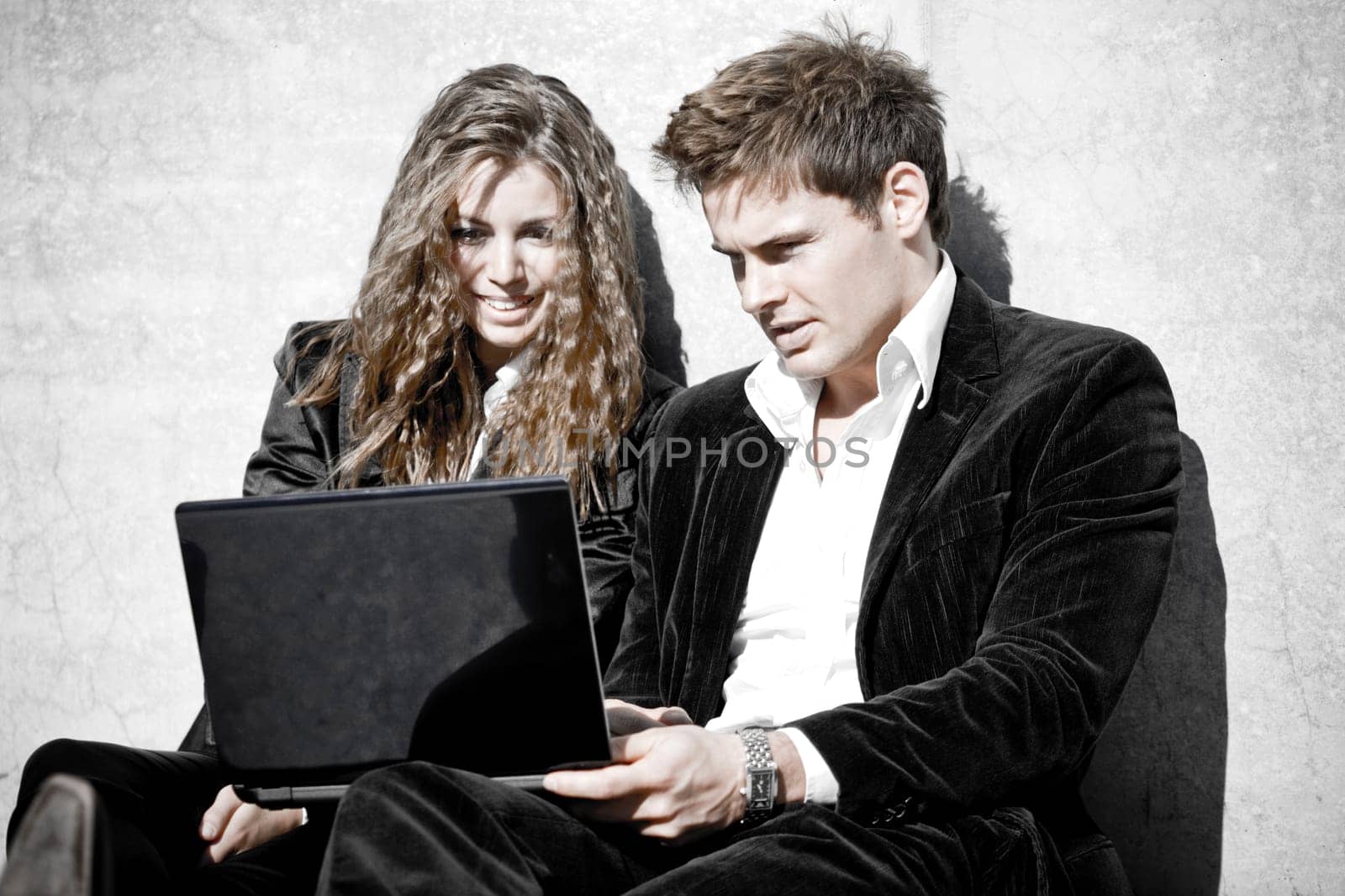 Young Corporate Couple With Laptop In Contrast