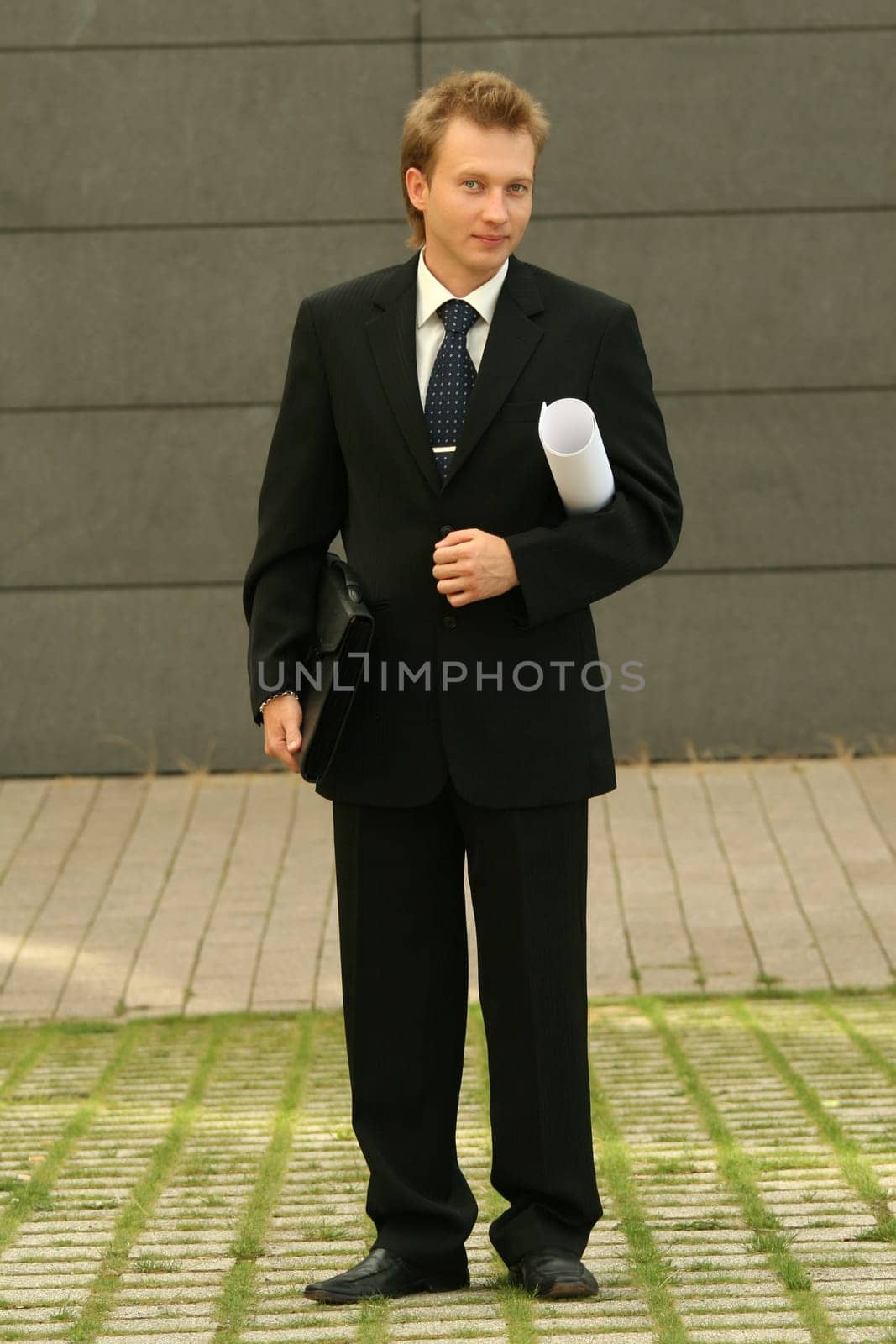 businessman with bag and blueprint