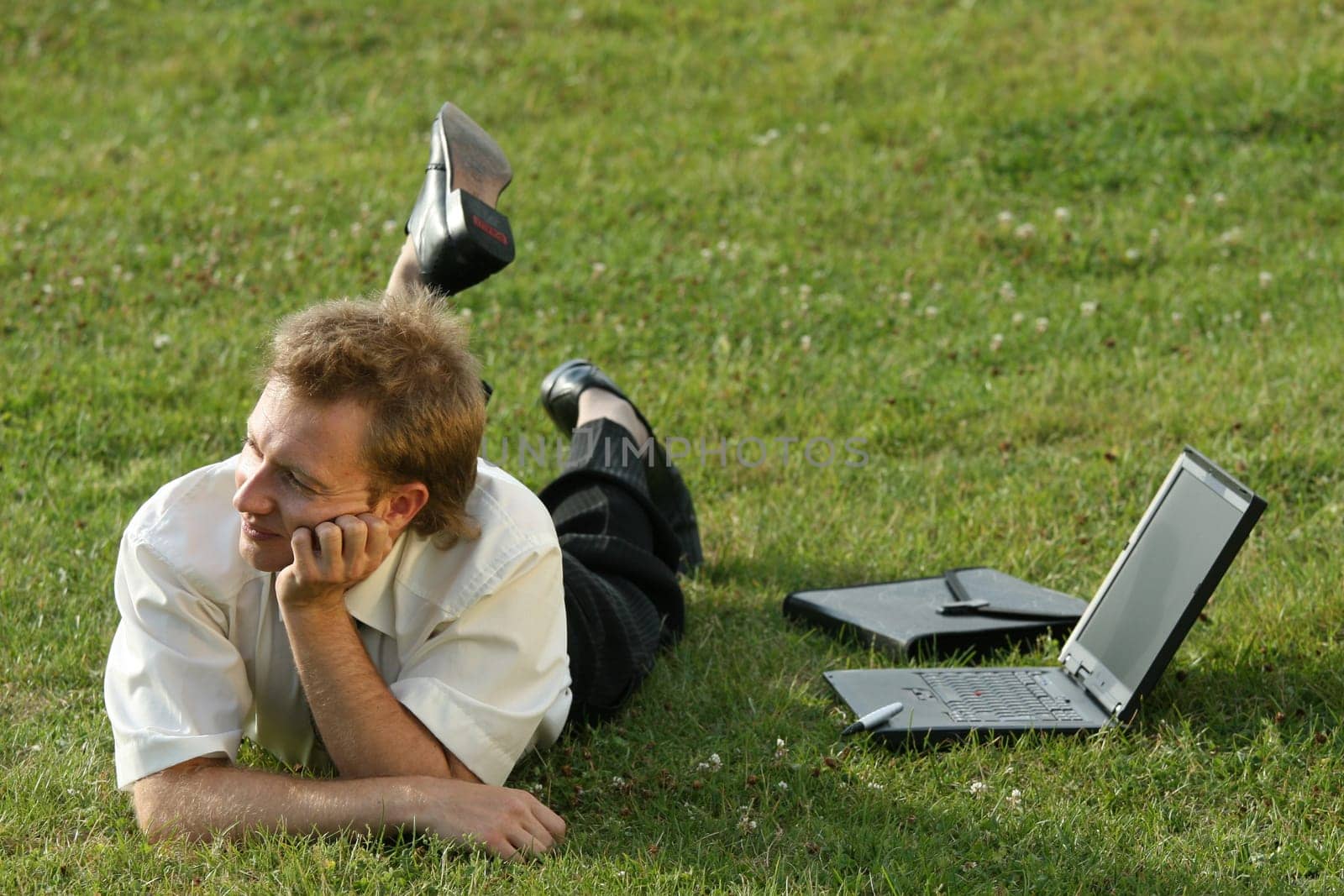 relaxing businessman on the grass
